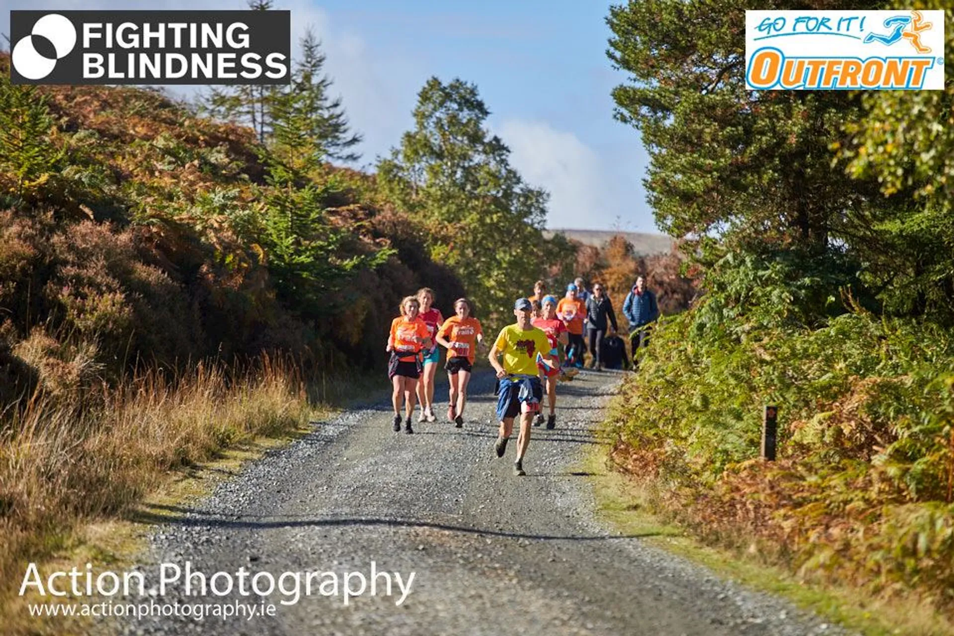 The image shows a group of runners in a natural setting, likely participating in a