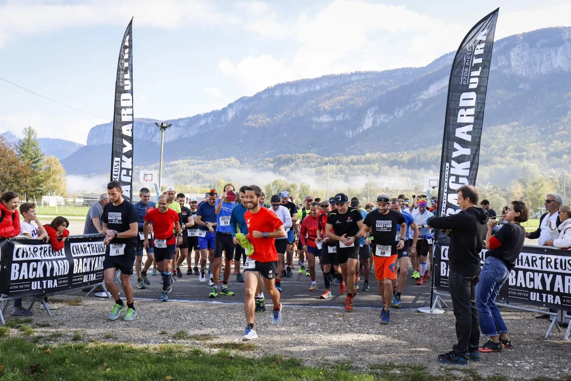 This image captures a group of runners at the start of an outdoor running event.