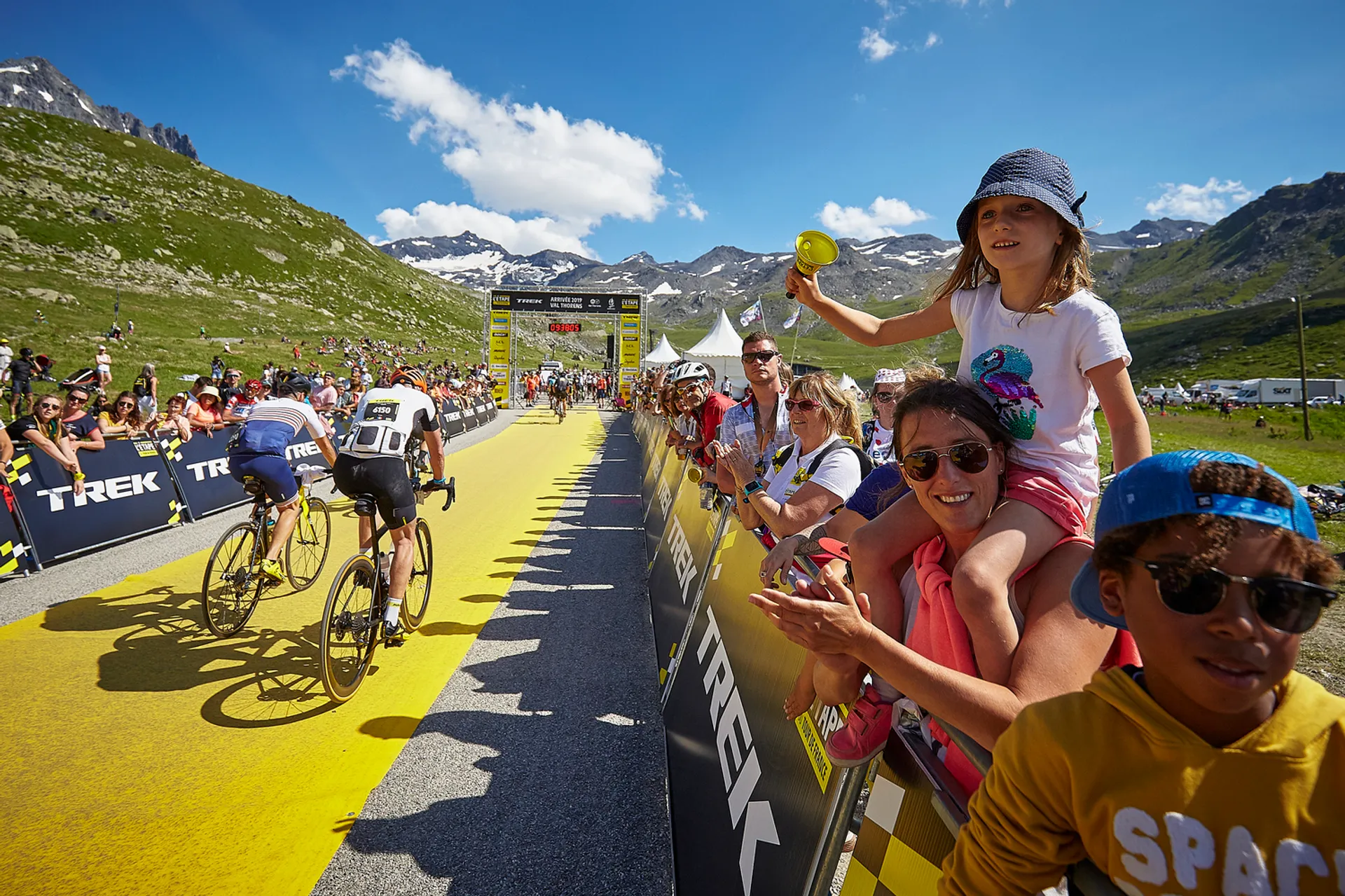 This image depicts a scene from a cycling event, most likely a professional road cycling