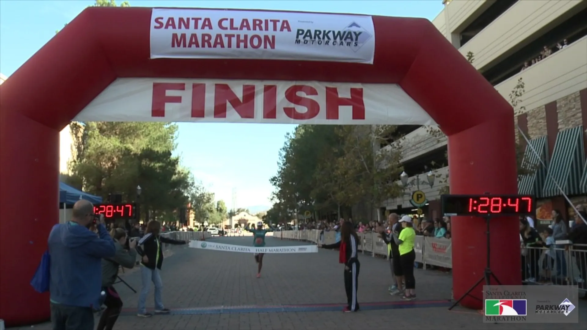 The image shows a finish line arch for the Santa Clarita Marathon, presented by