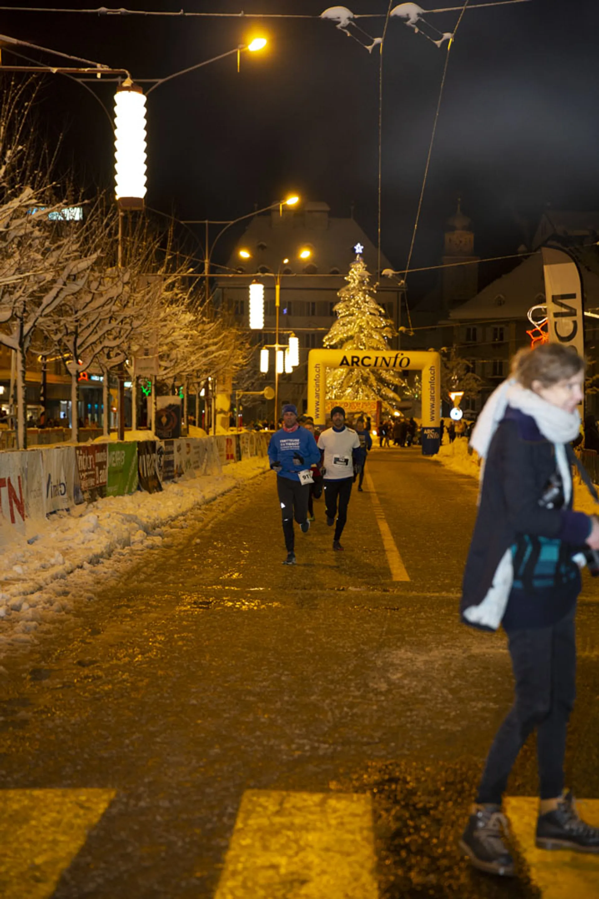 The image shows an outdoor night scene at what appears to be a public event.