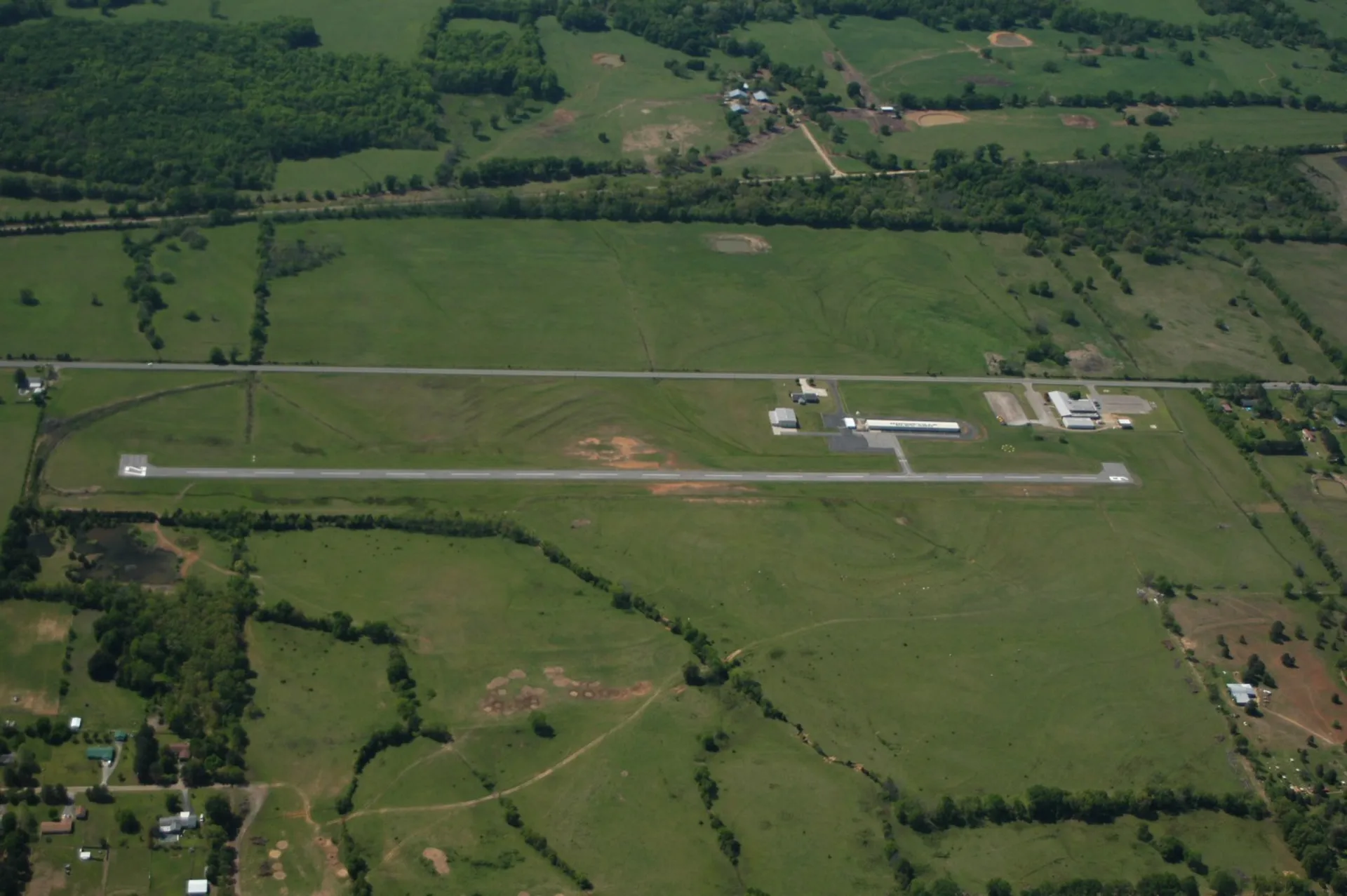 The image shows an aerial view of a small airport or airfield. The most