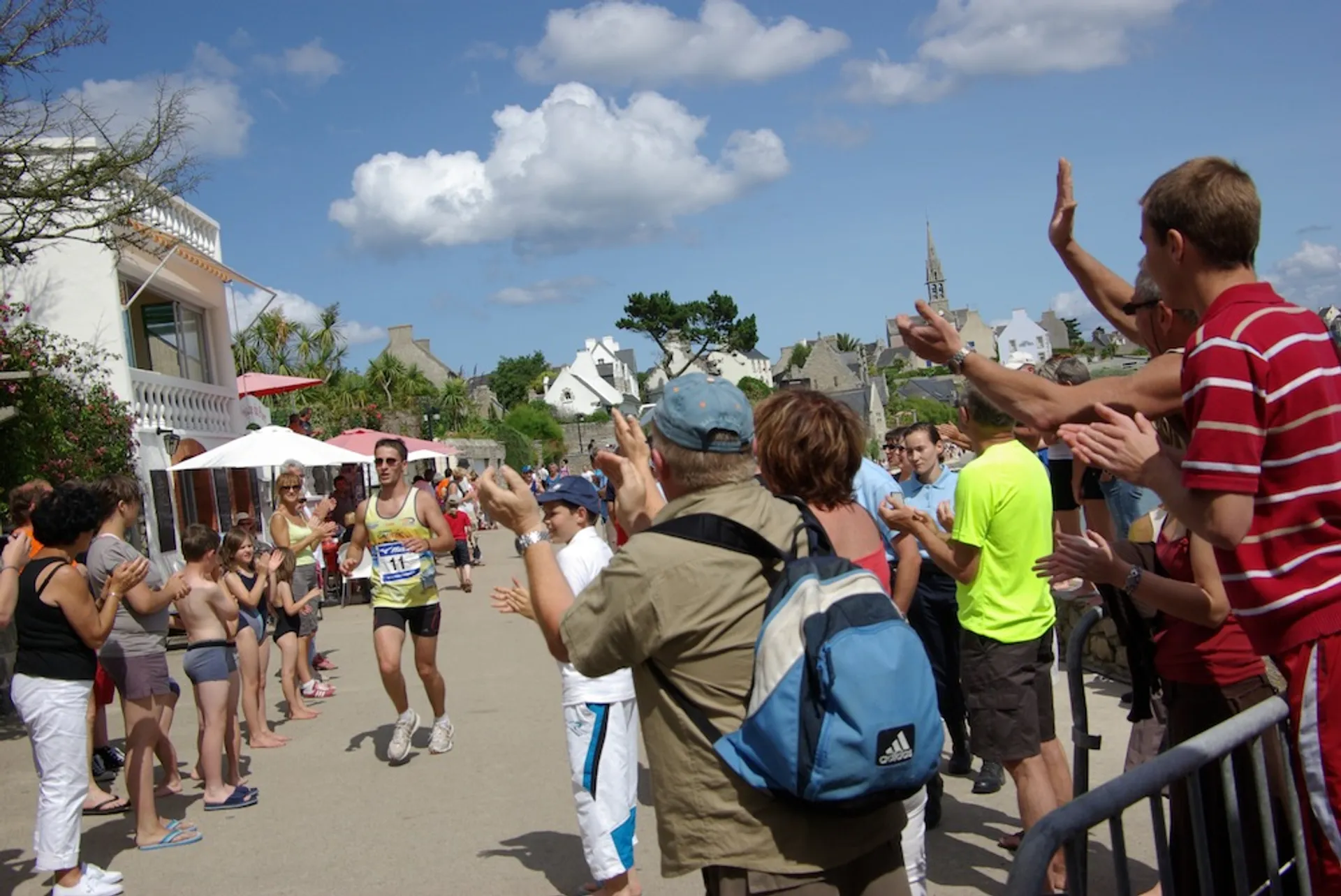 The image shows a group of people participating in a running event or a marathon.