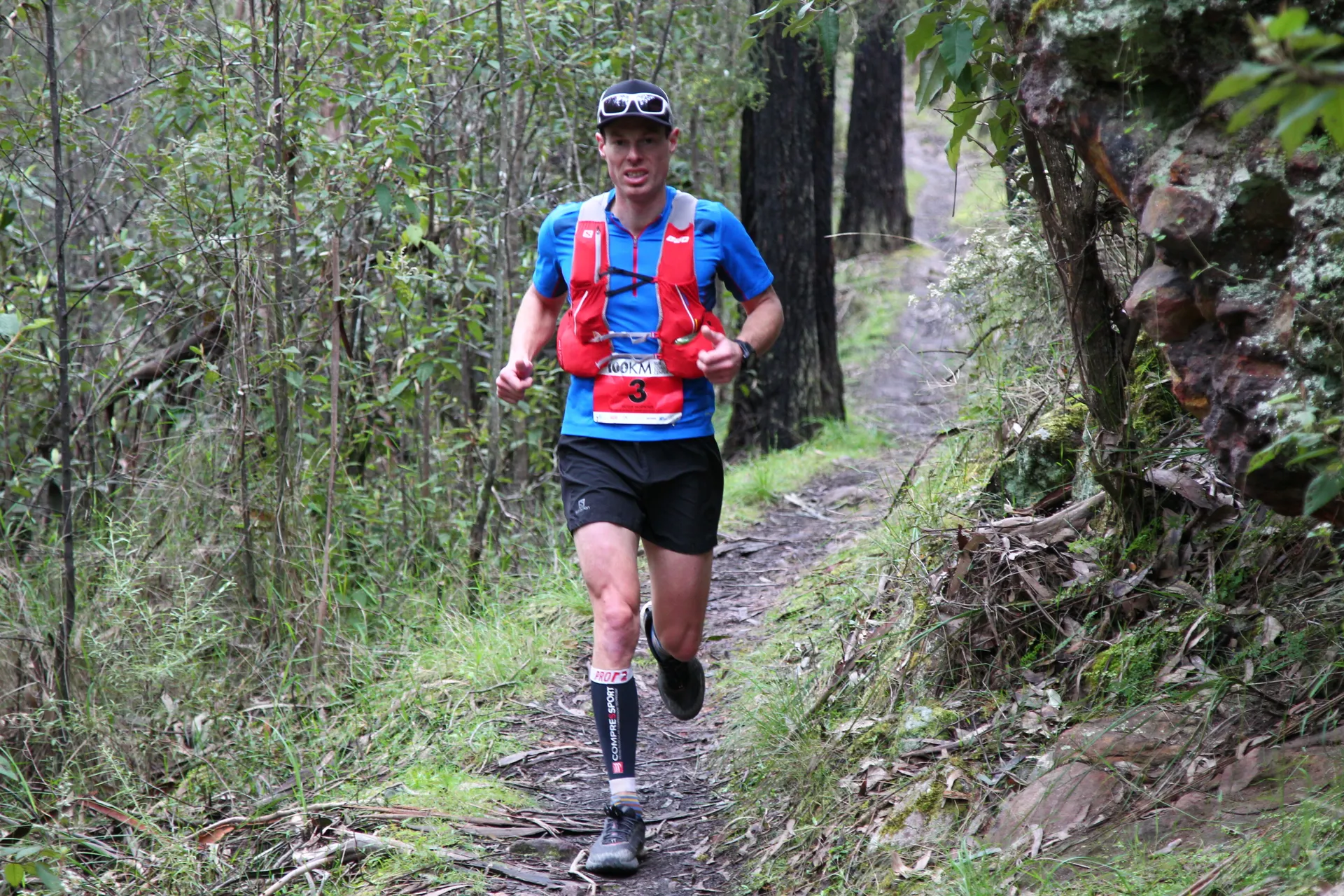 In the image, there is a person who appears to be participating in a trail