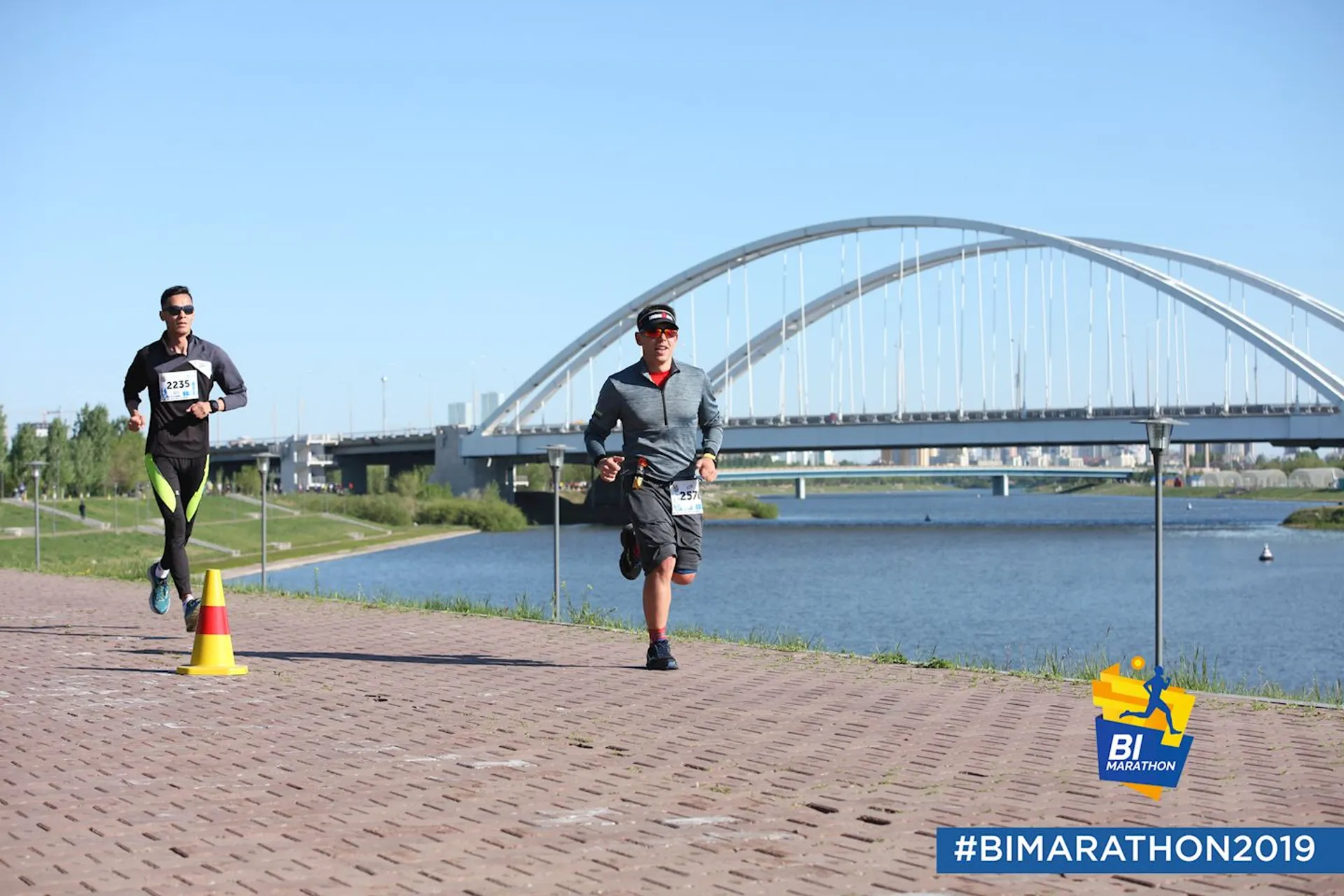 This image shows two people participating in a running event, most likely a marathon or