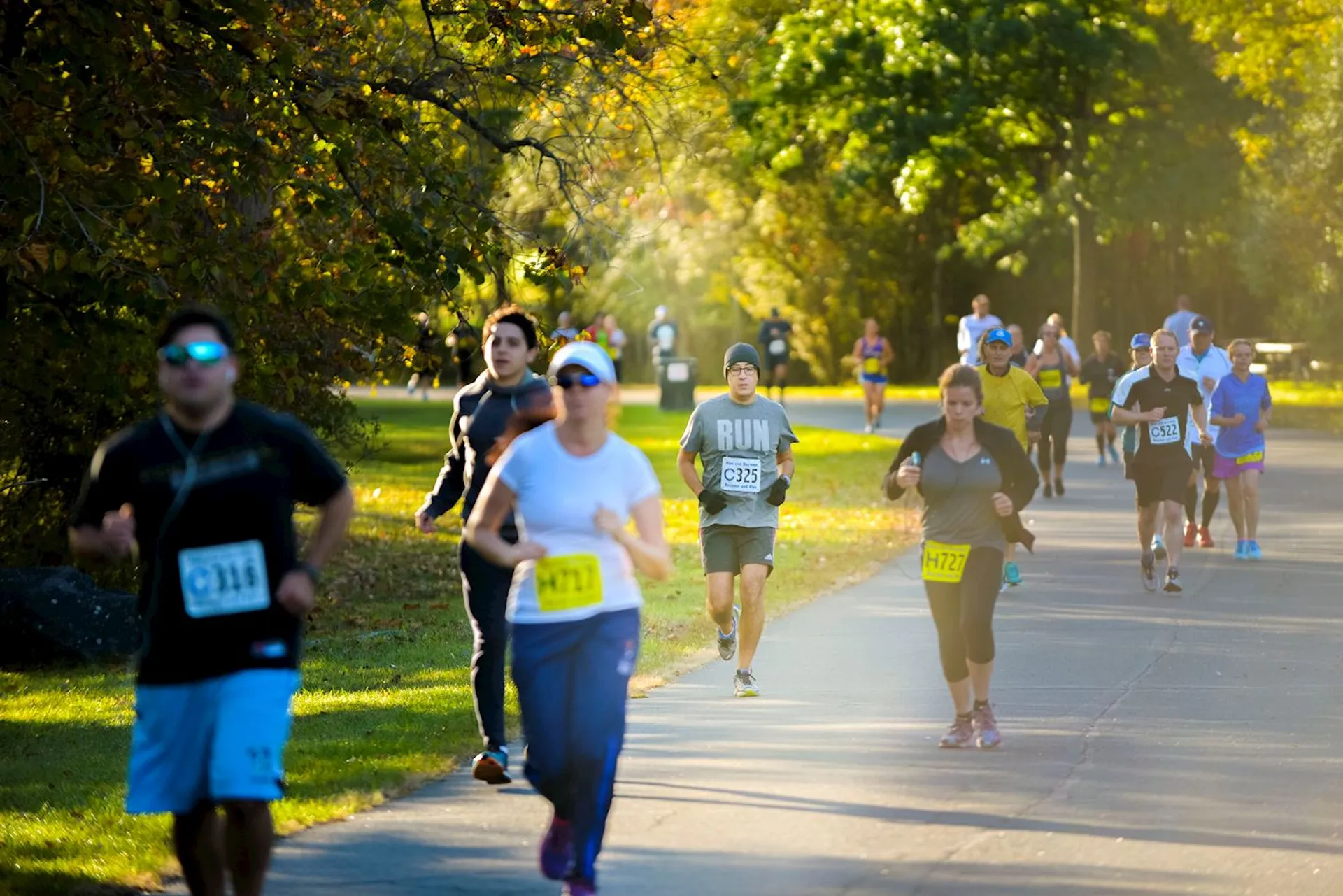 The image shows a group of people participating in a running event. They are wearing