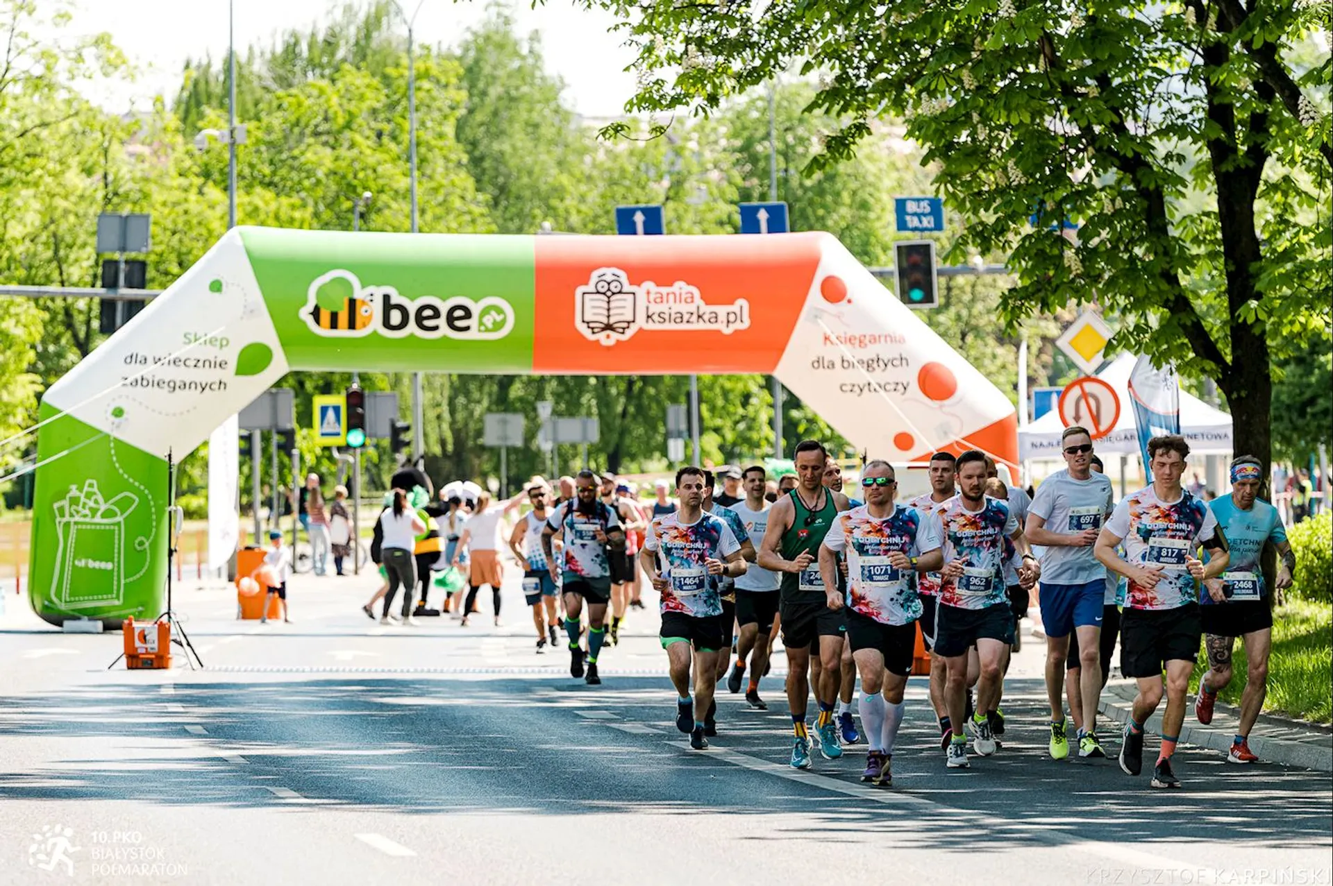 The image shows a group of runners participating in a race or marathon. They are