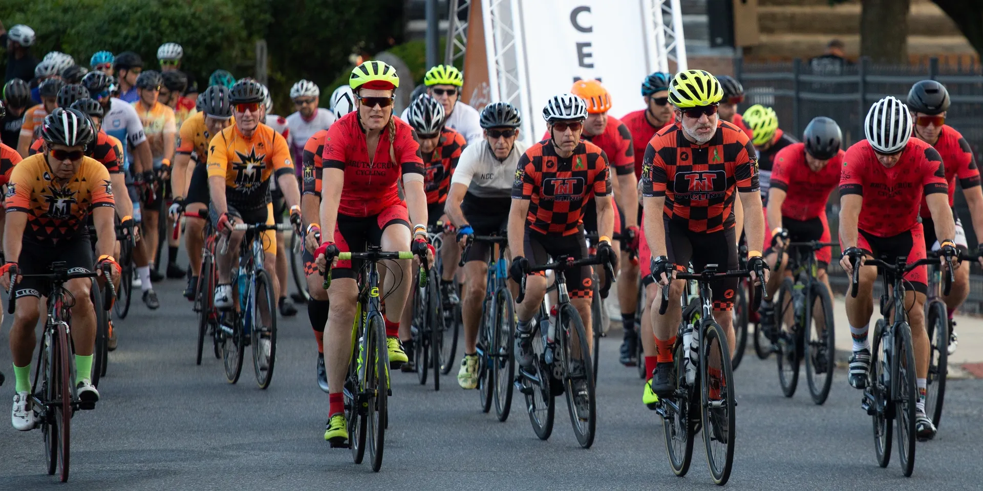 The image depicts a group of cyclists collectively participating in a cycling event or race.