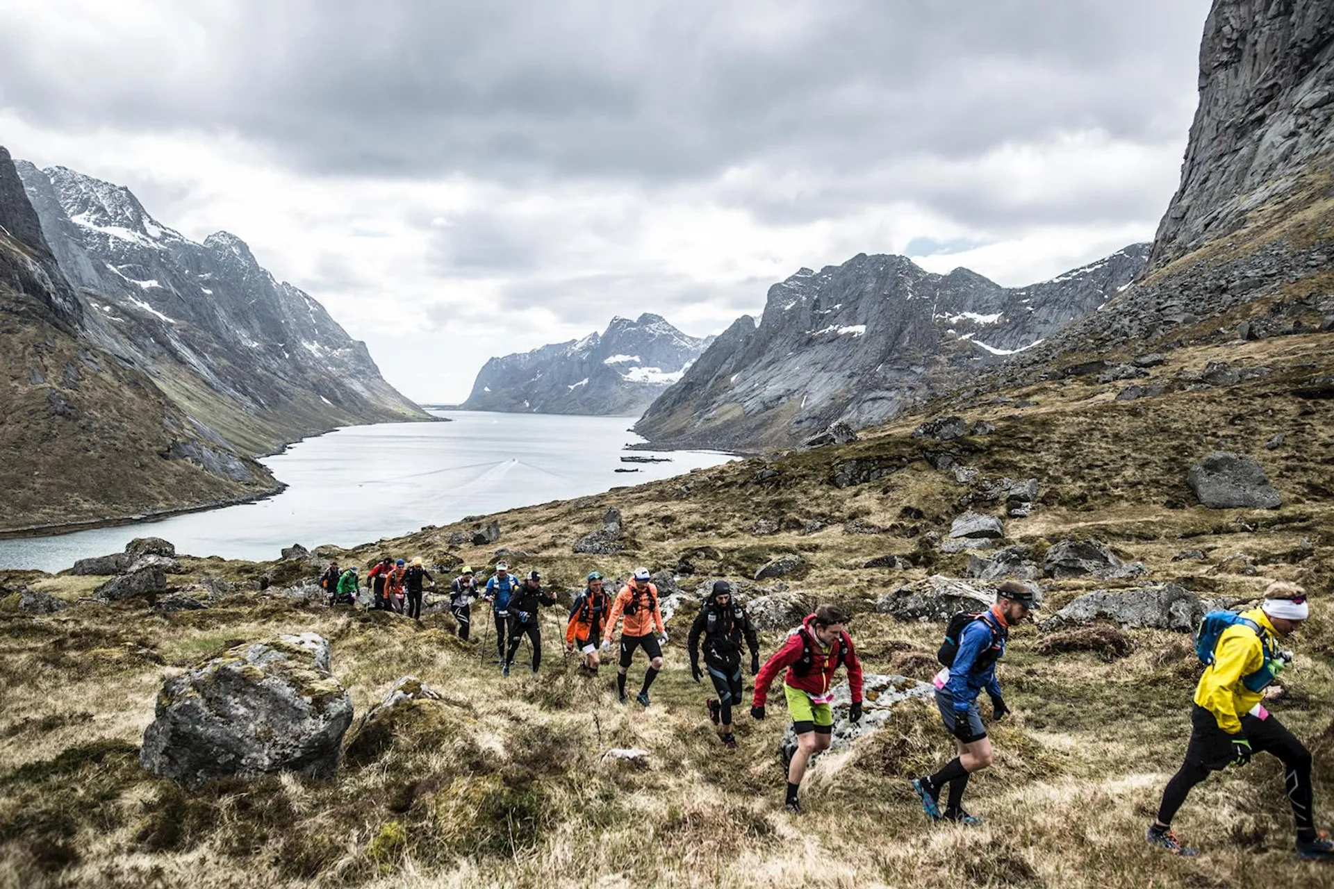 The image shows a group of people engaged in a trail running event or a hike
