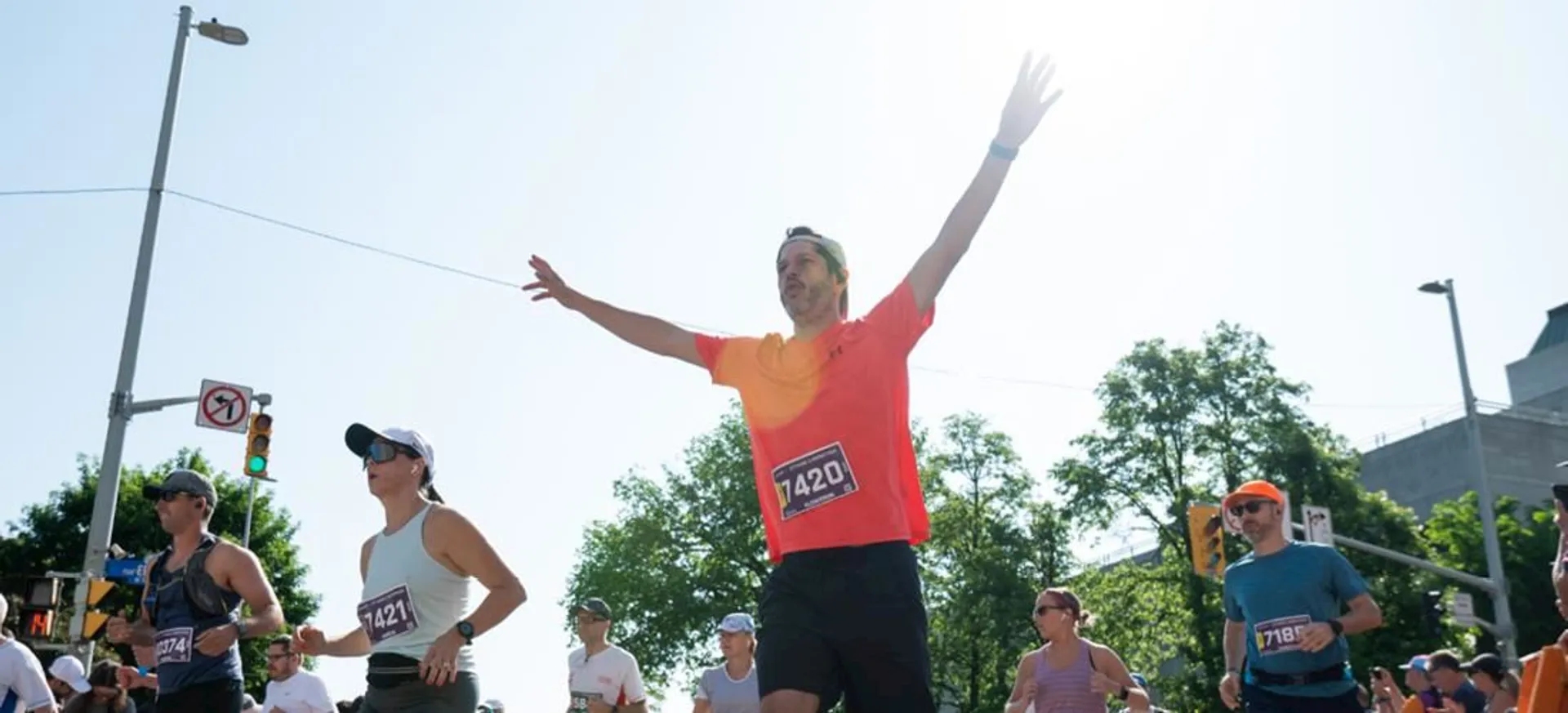The image shows a group of individuals participating in what appears to be a running event