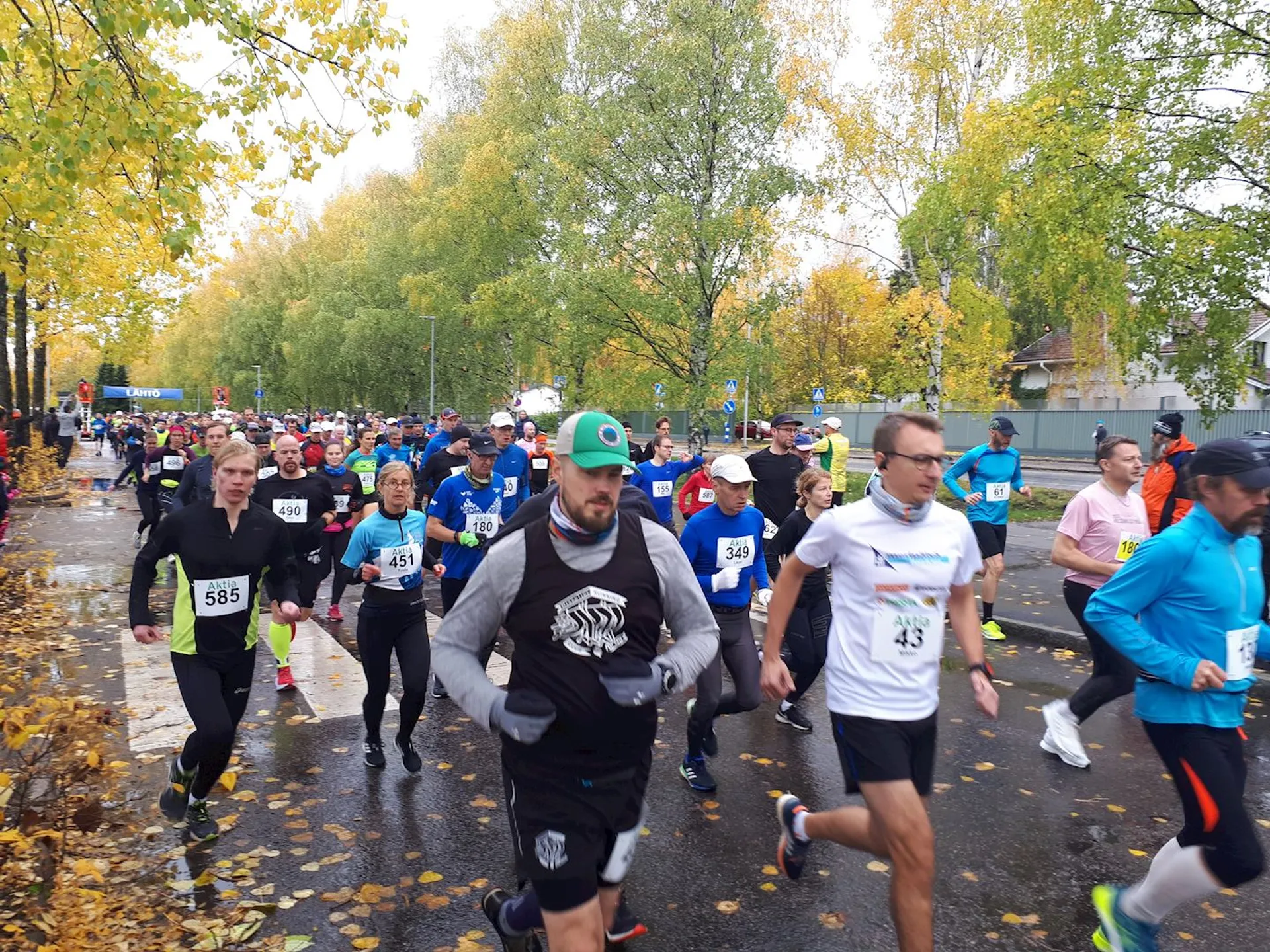 The image shows a group of people participating in a running event. They appear to