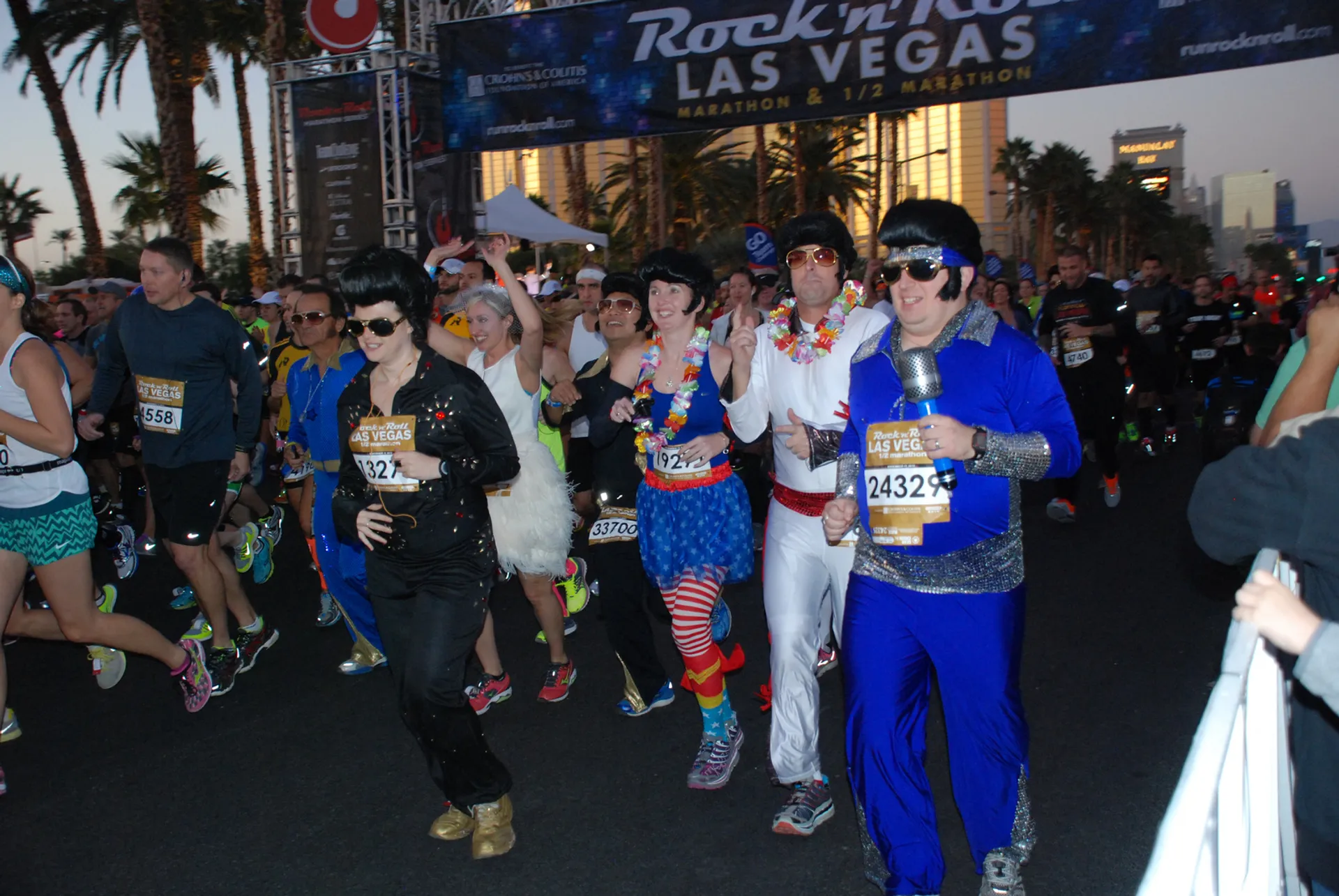 The image depicts a group of individuals taking part in a marathon event. The setting