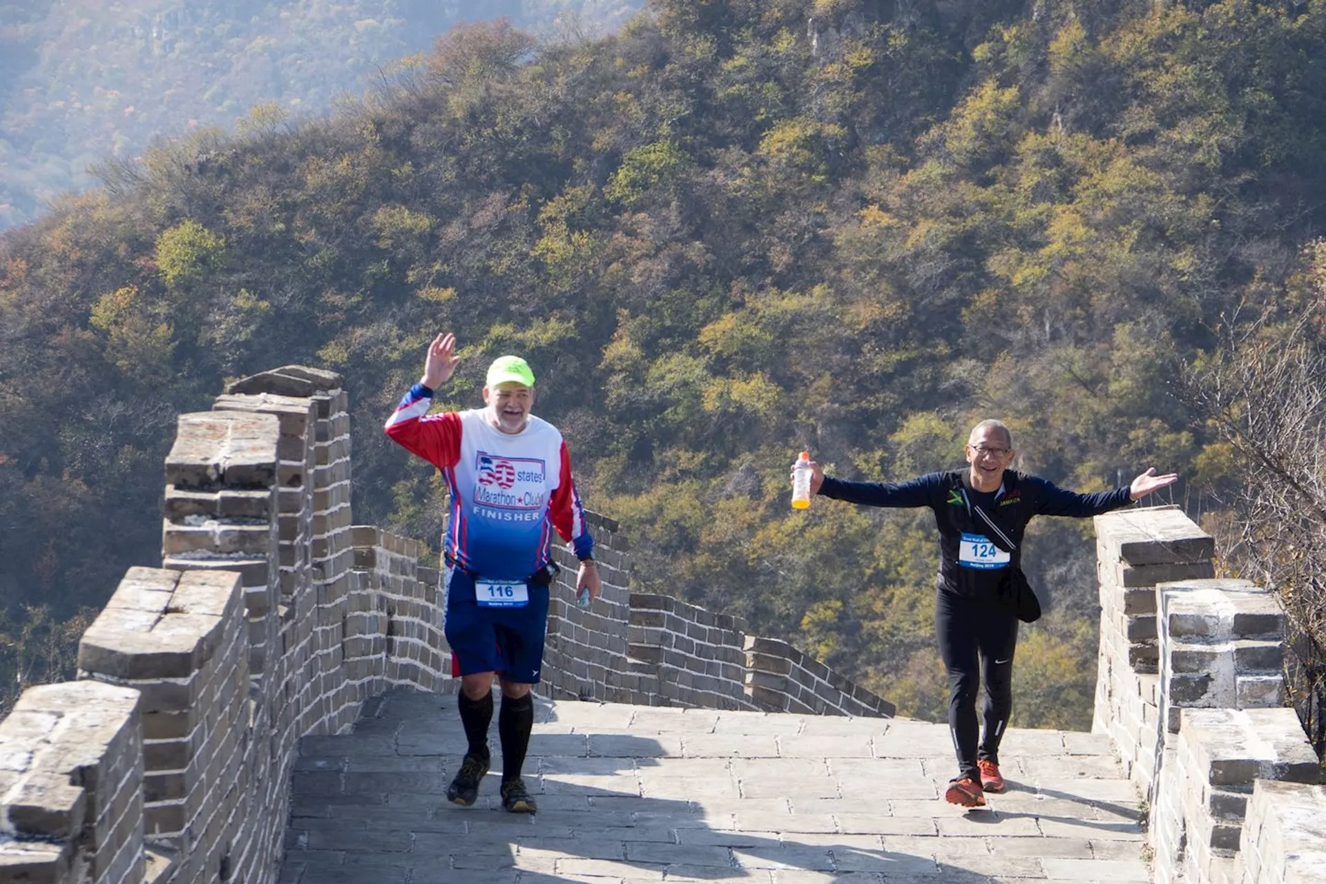 The image appears to depict two individuals participating in a running event along the Great Wall