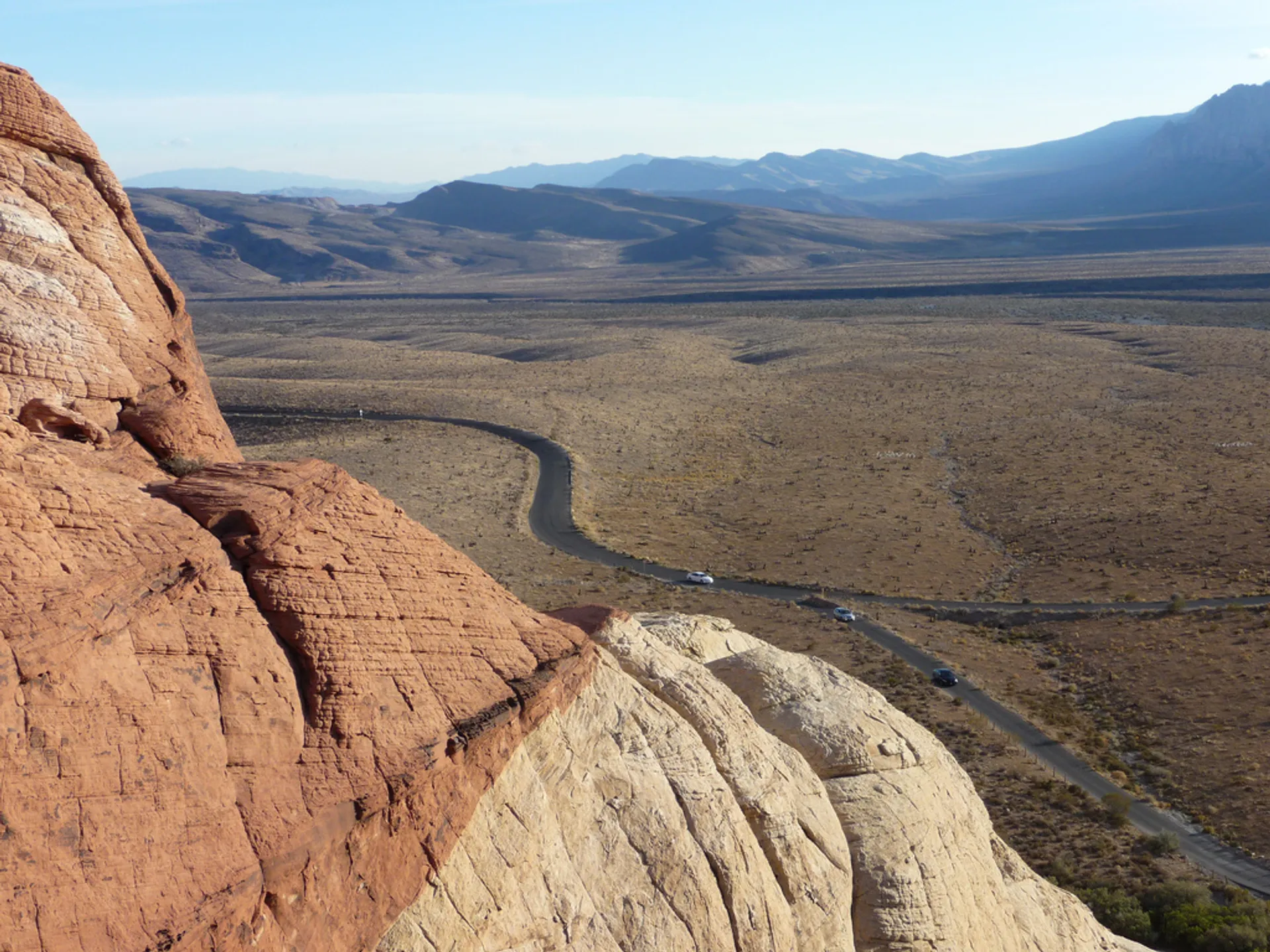 The image shows a landscape with striking geological features. In the foreground, there are