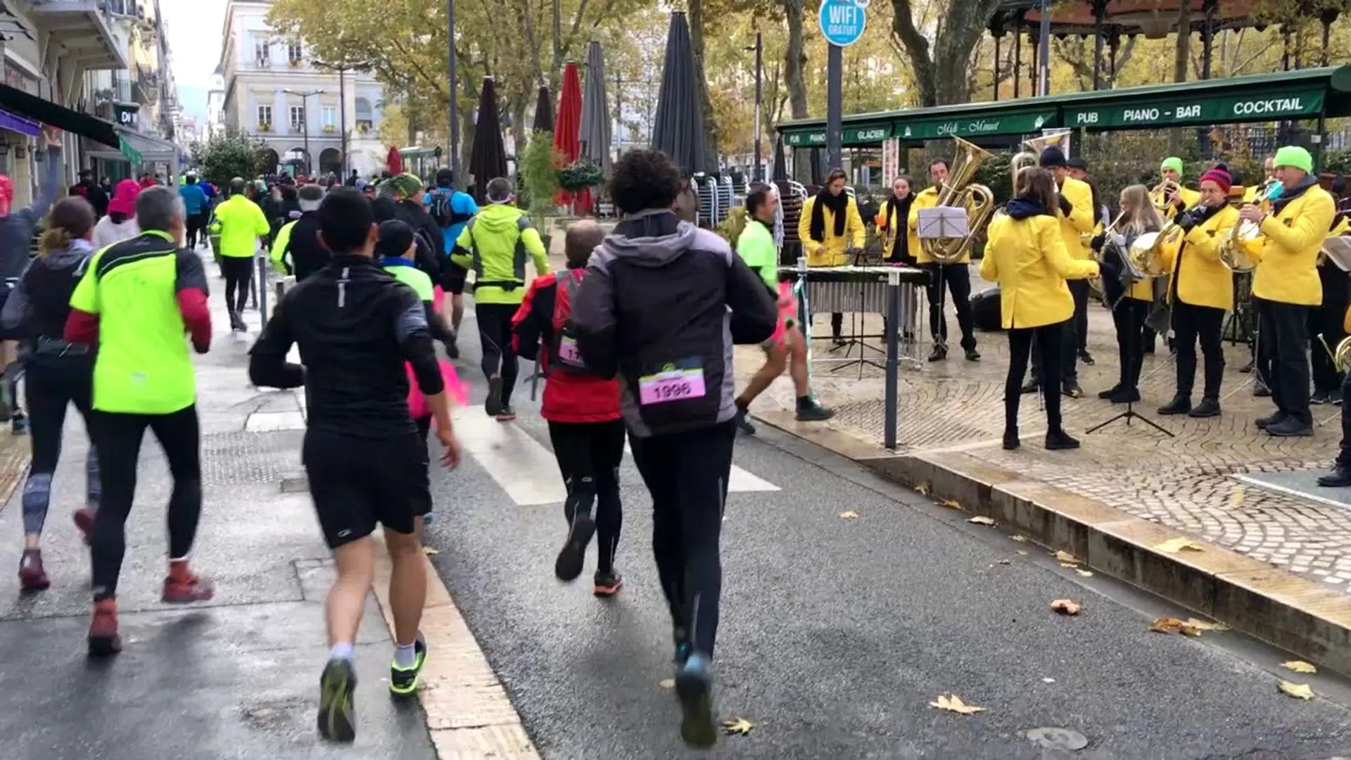 This image shows a group of runners in the midst of a road race. They