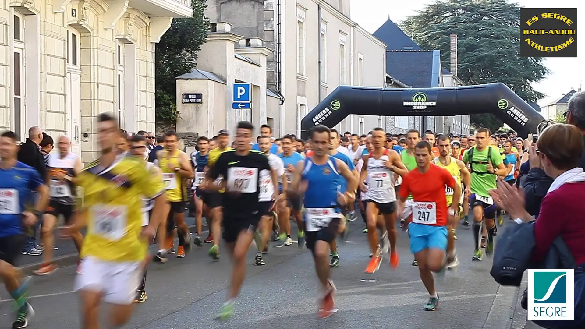 This image appears to capture the start of a road running race. Participants are seen