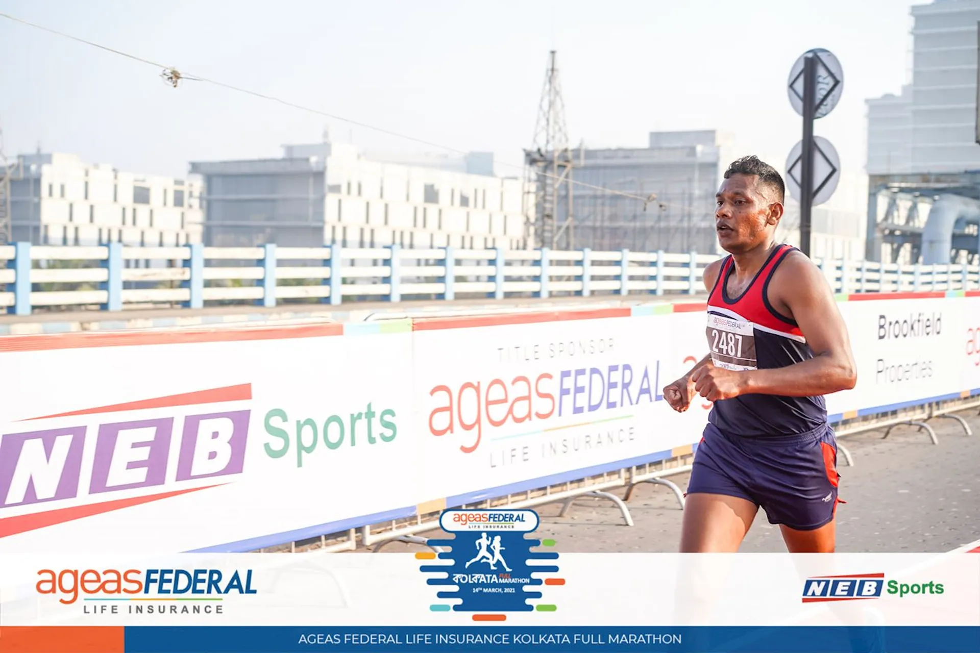 The image shows a male runner competing in a marathon event, as indicated by his