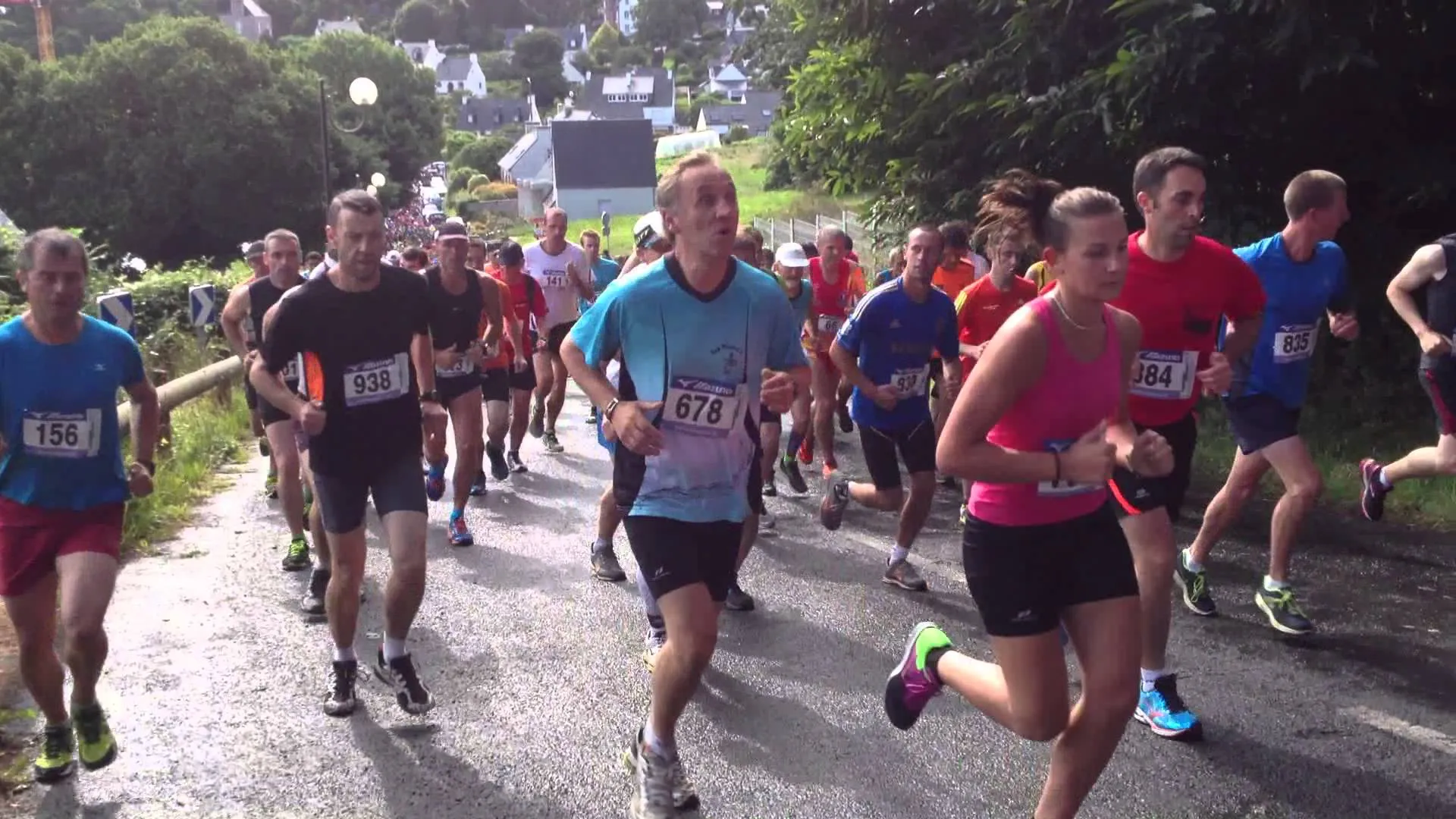 The image shows a group of people participating in a running event. They are dressed