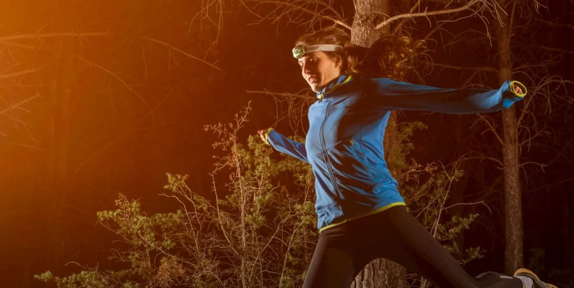 This image features a person running outdoors at night or during low-light conditions. The