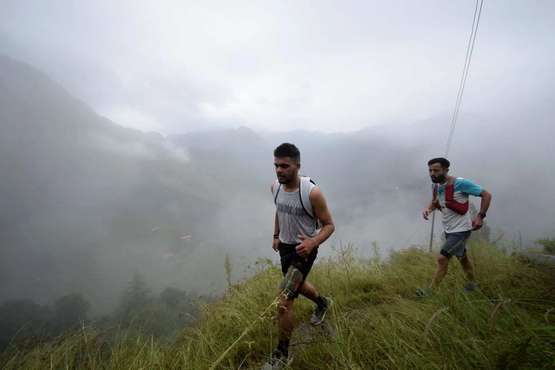 In the image, there are two people who appear to be men engaged in trail