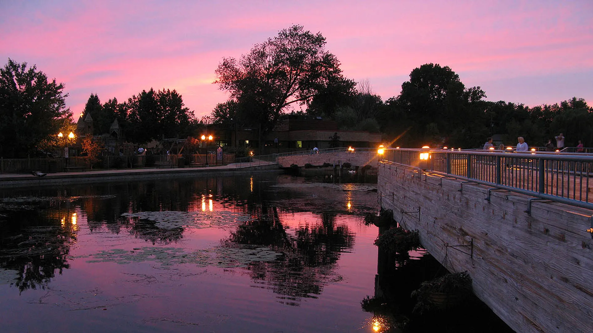 This image displays a tranquil evening setting. You can see a body of water,