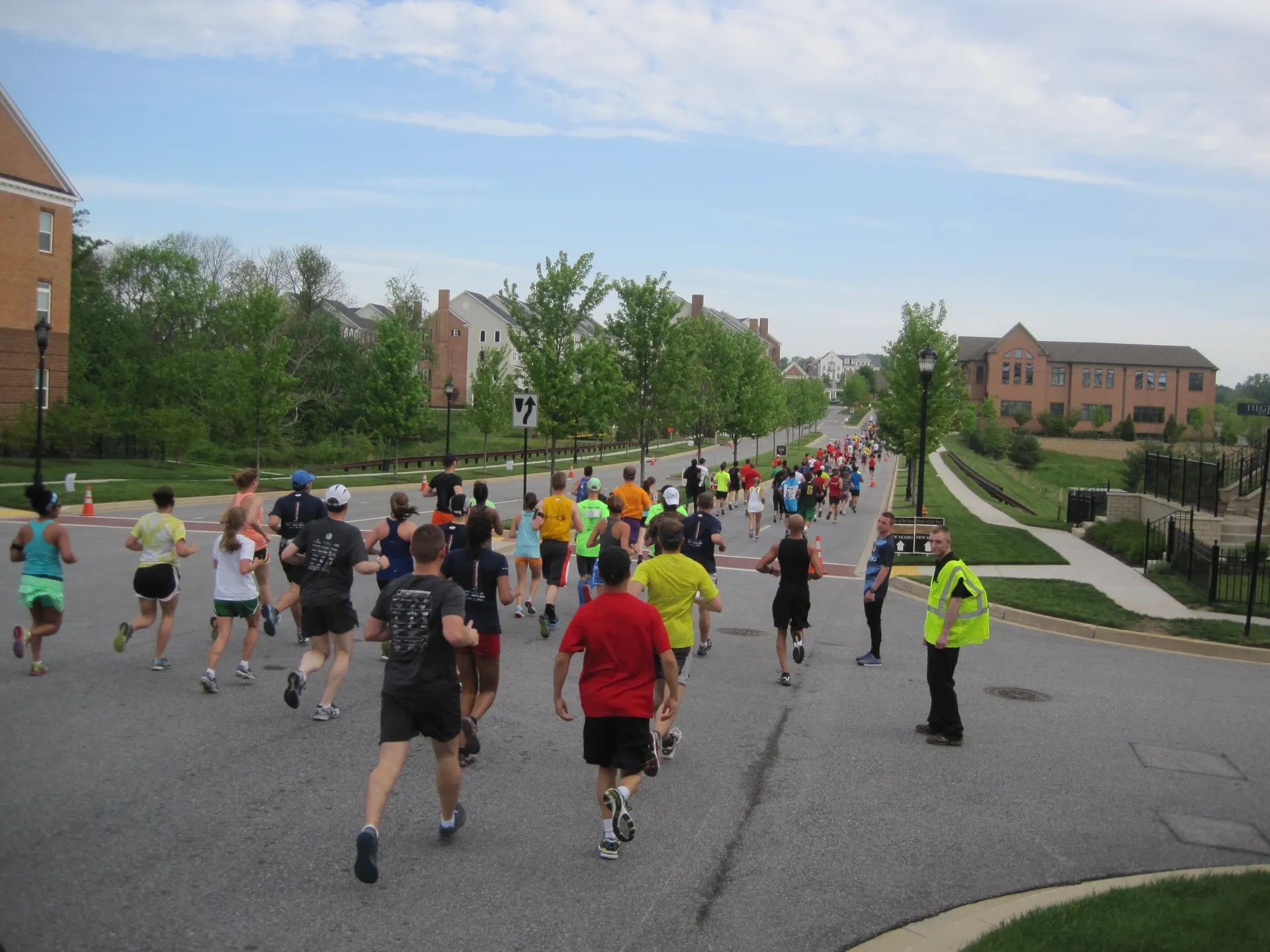 The image depicts a group of people participating in a running event, likely a race