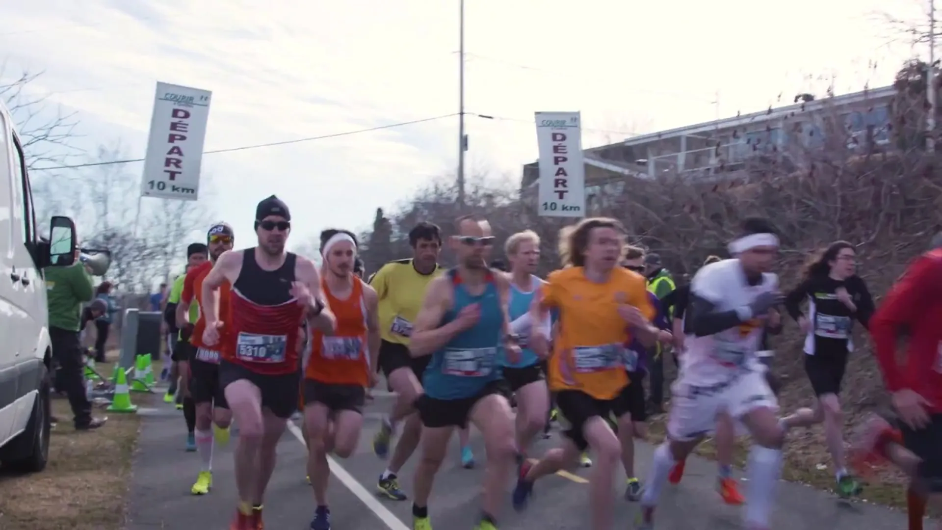 The image depicts a group of people participating in a running event, possibly a race