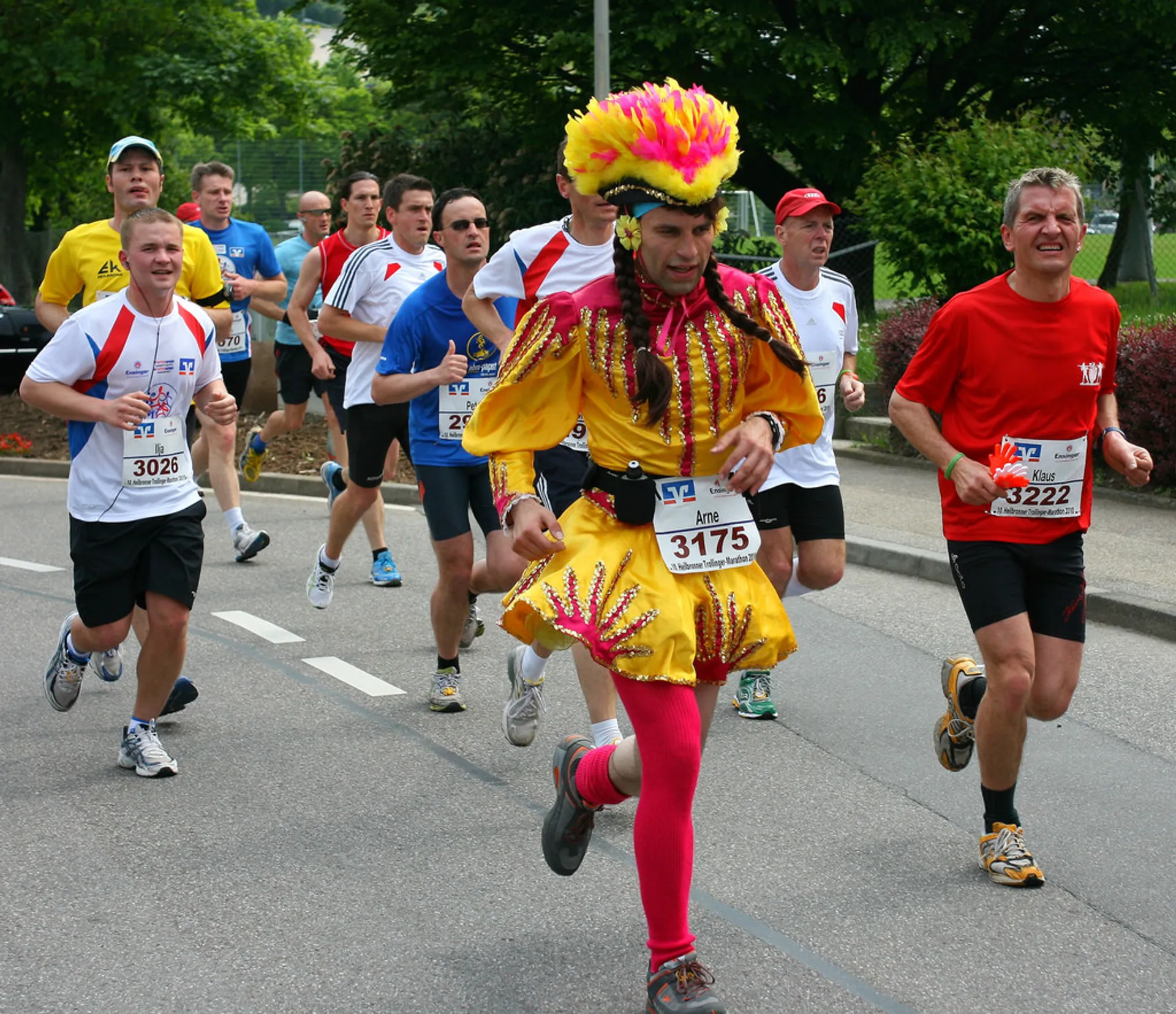 The image shows a group of people engaged in a running event, likely a marathon