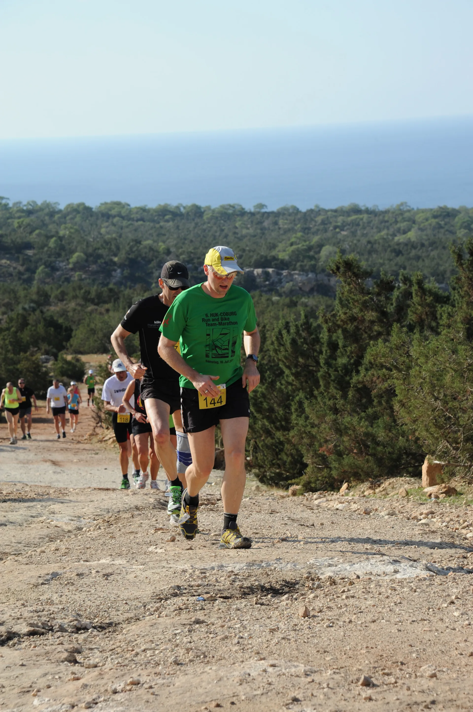 The image depicts a group of people participating in an outdoor running event, possibly a