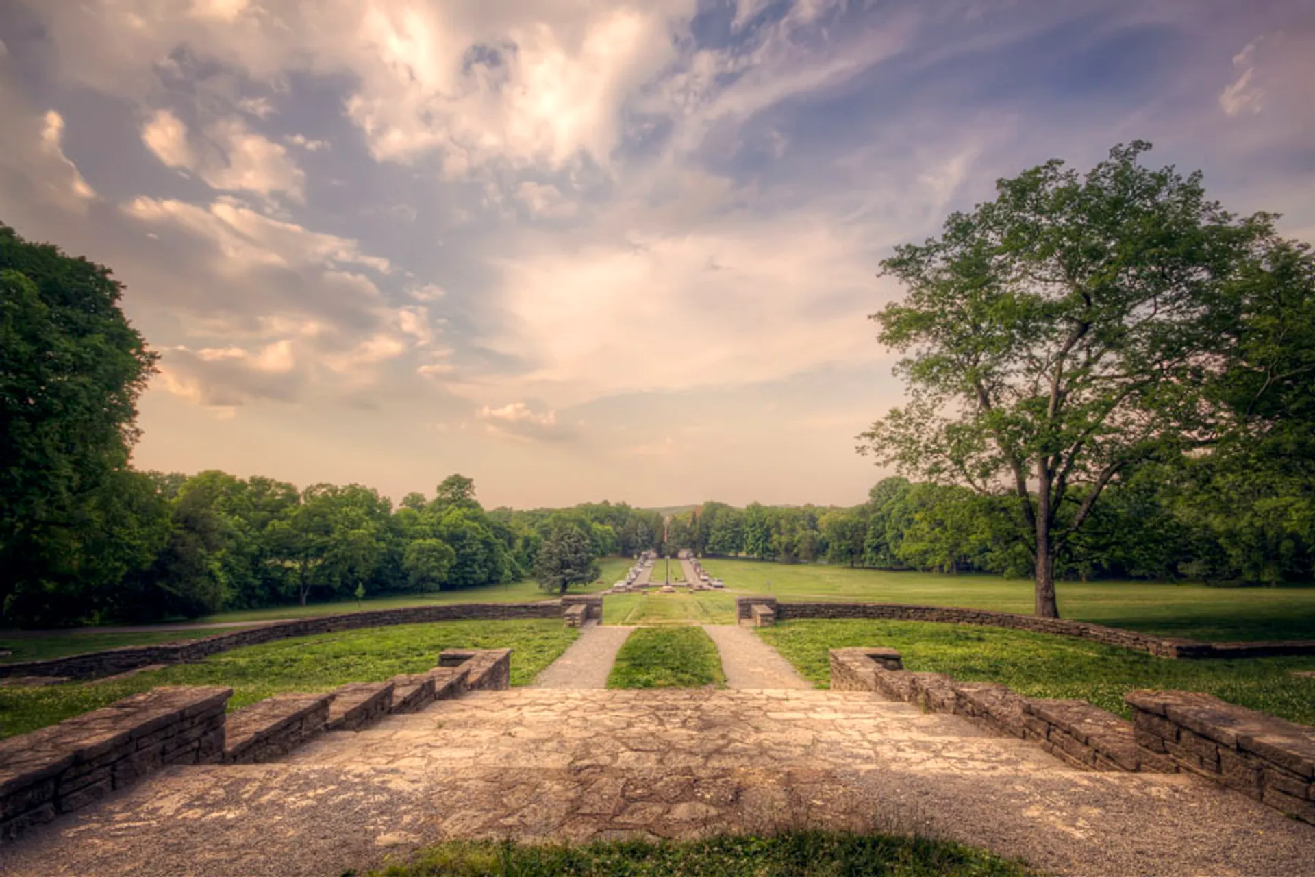 The image shows a serene park landscape captured from an elevated vantage point. In