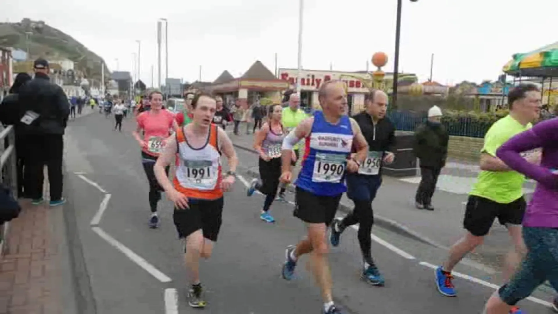 The image shows a group of people participating in a running event, likely a marathon