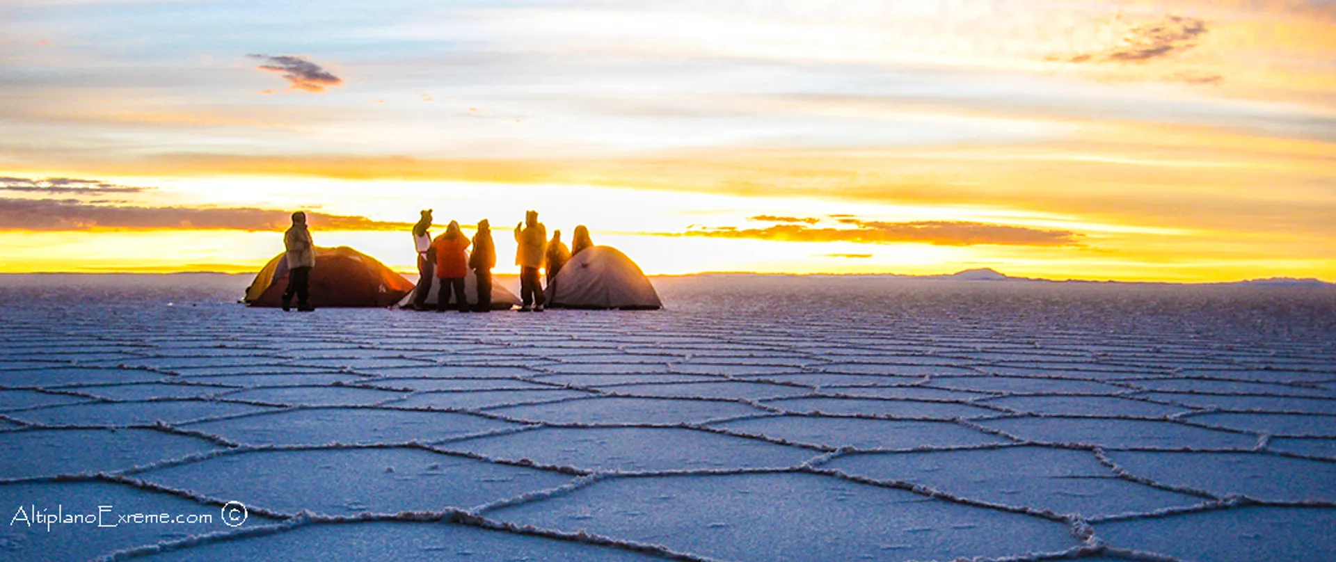 The image shows a captivating scene of a group of people in a vast expanse