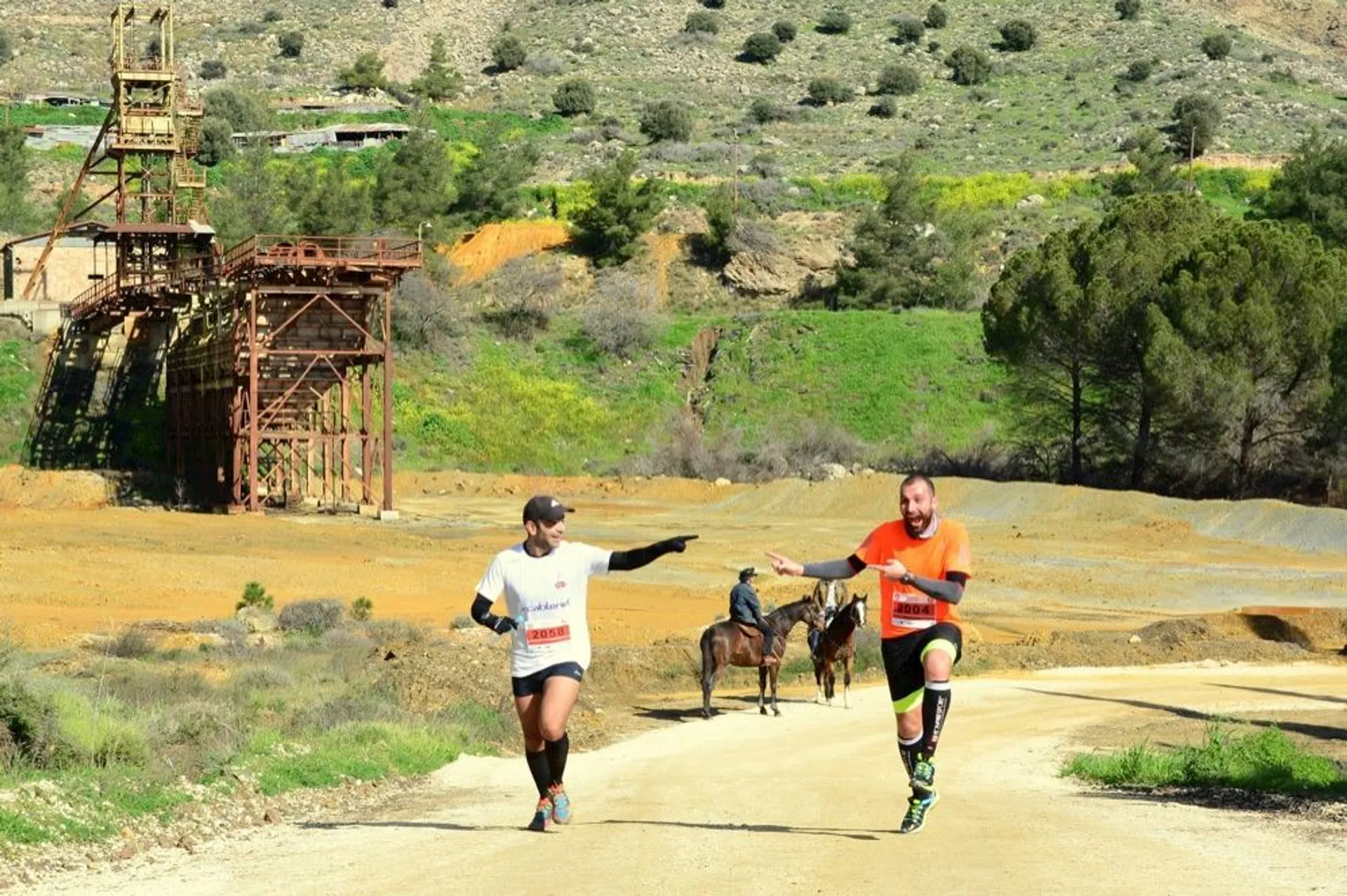 This image shows two individuals participating in a running event, with one of them reaching