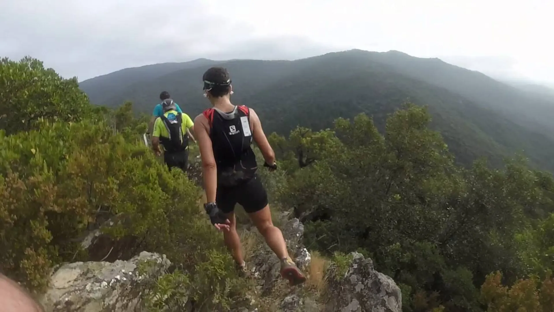 This image depicts a group of people engaged in outdoor activity, possibly hiking or trail