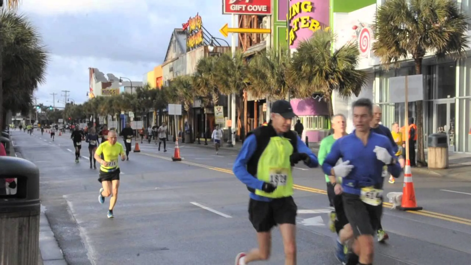This image depicts a group of runners participating in a road running event or marathon.
