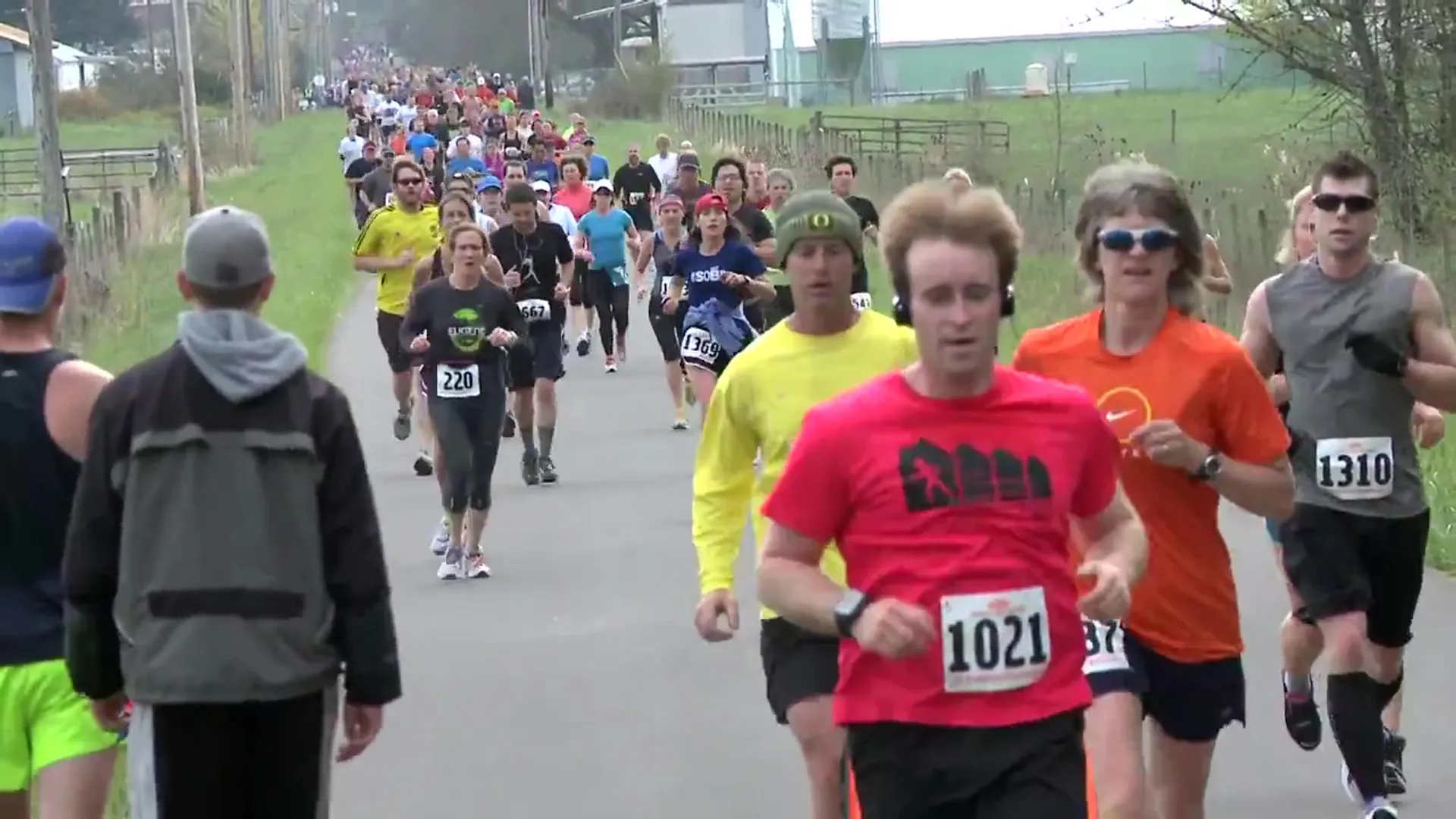The image shows a group of people participating in a running event. They are wearing