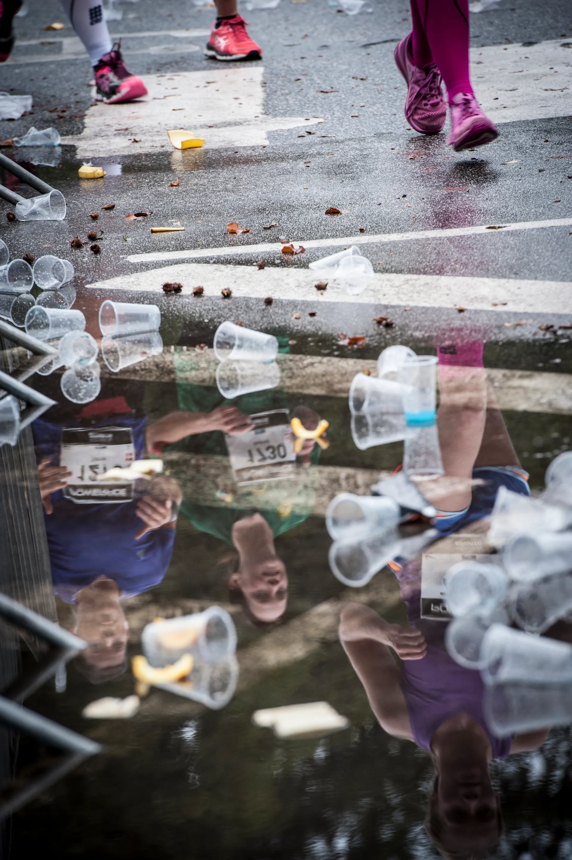 The image depicts a scene from a sporting event, likely a marathon or race,