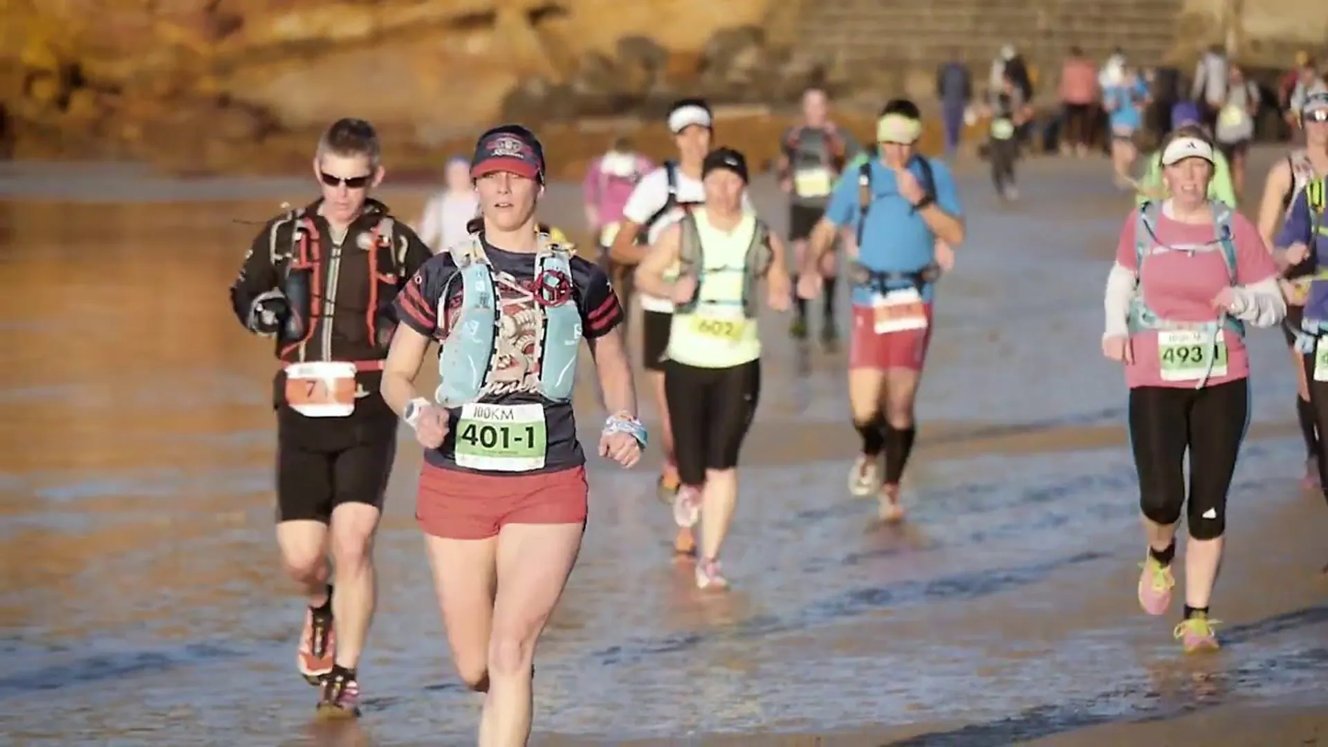 The image depicts a group of people participating in a running event, likely a race