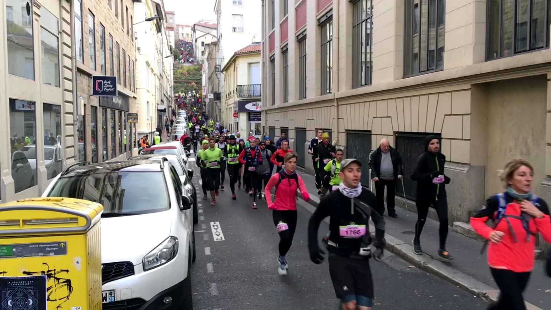 The image shows a group of people participating in a running event, possibly a marathon