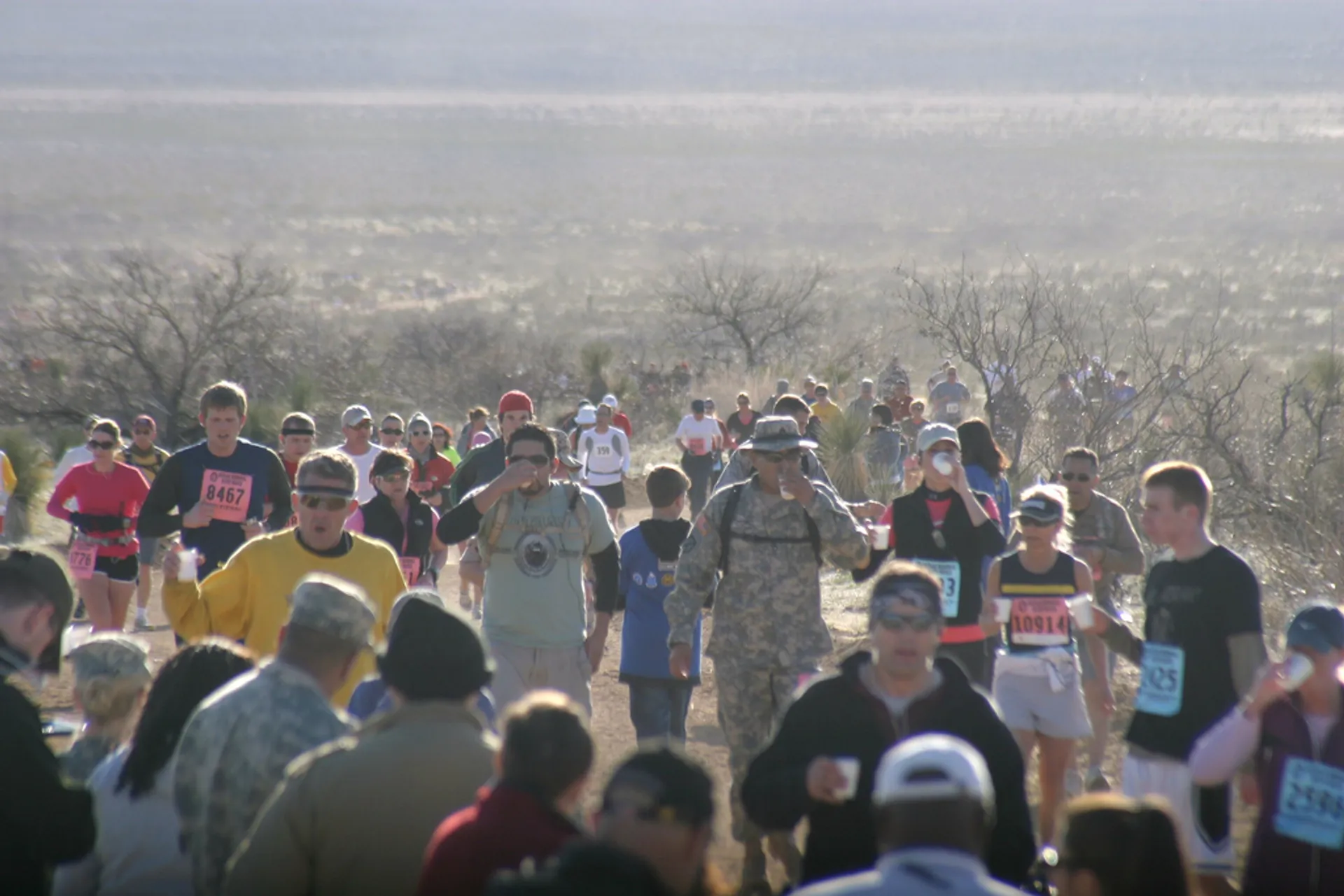 The image depicts a group of people participating in a running event, such as a