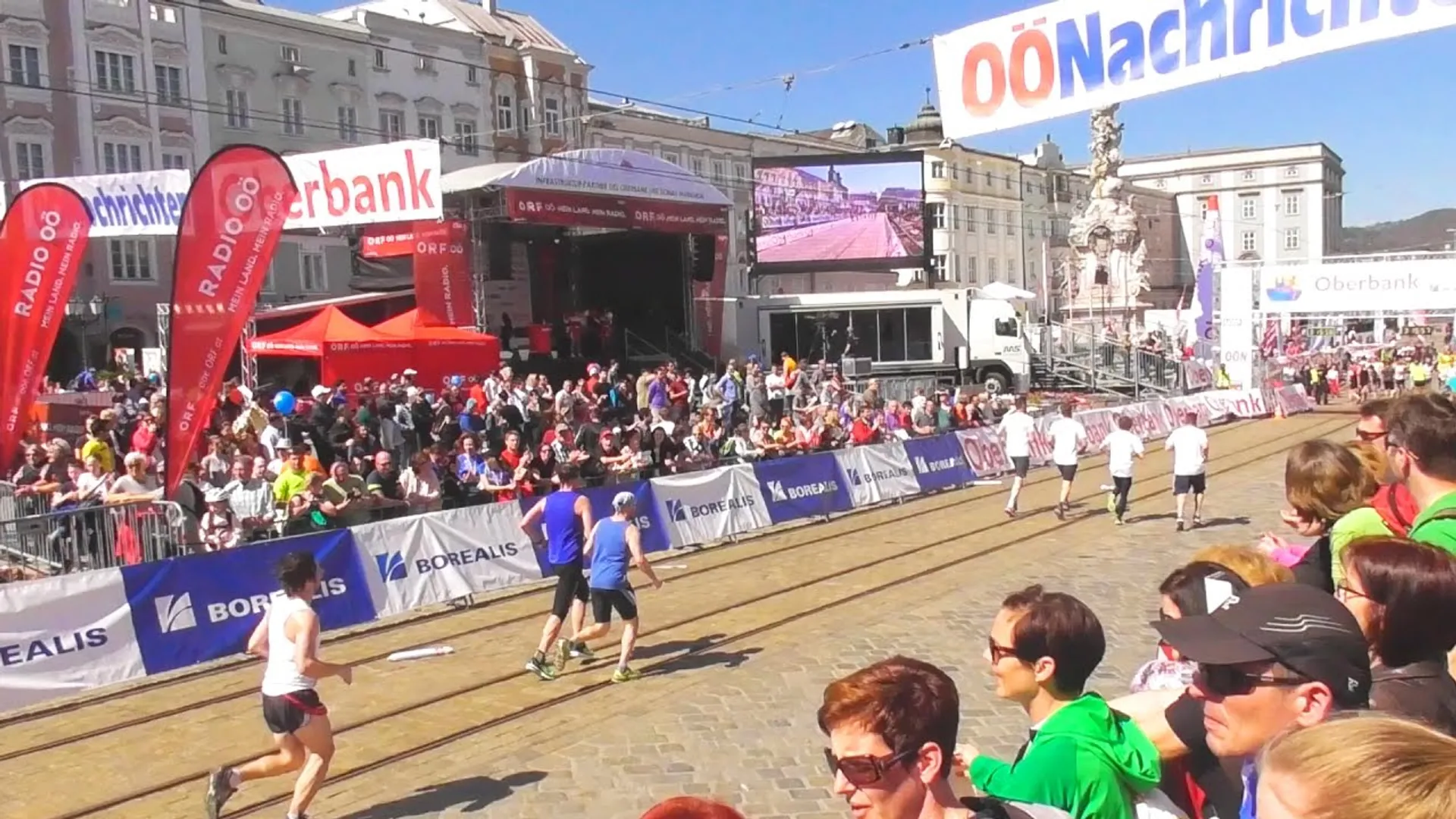 The image depicts a public outdoor event, possibly a sporting or running event, given