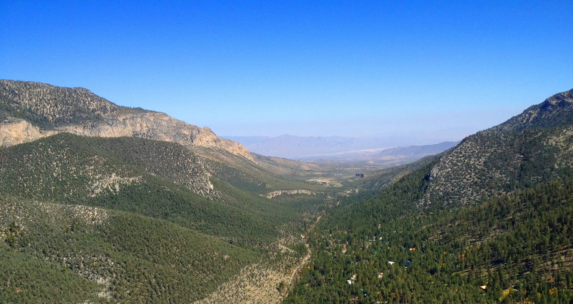 The image shows a panoramic view of a mountainous landscape. We can see a