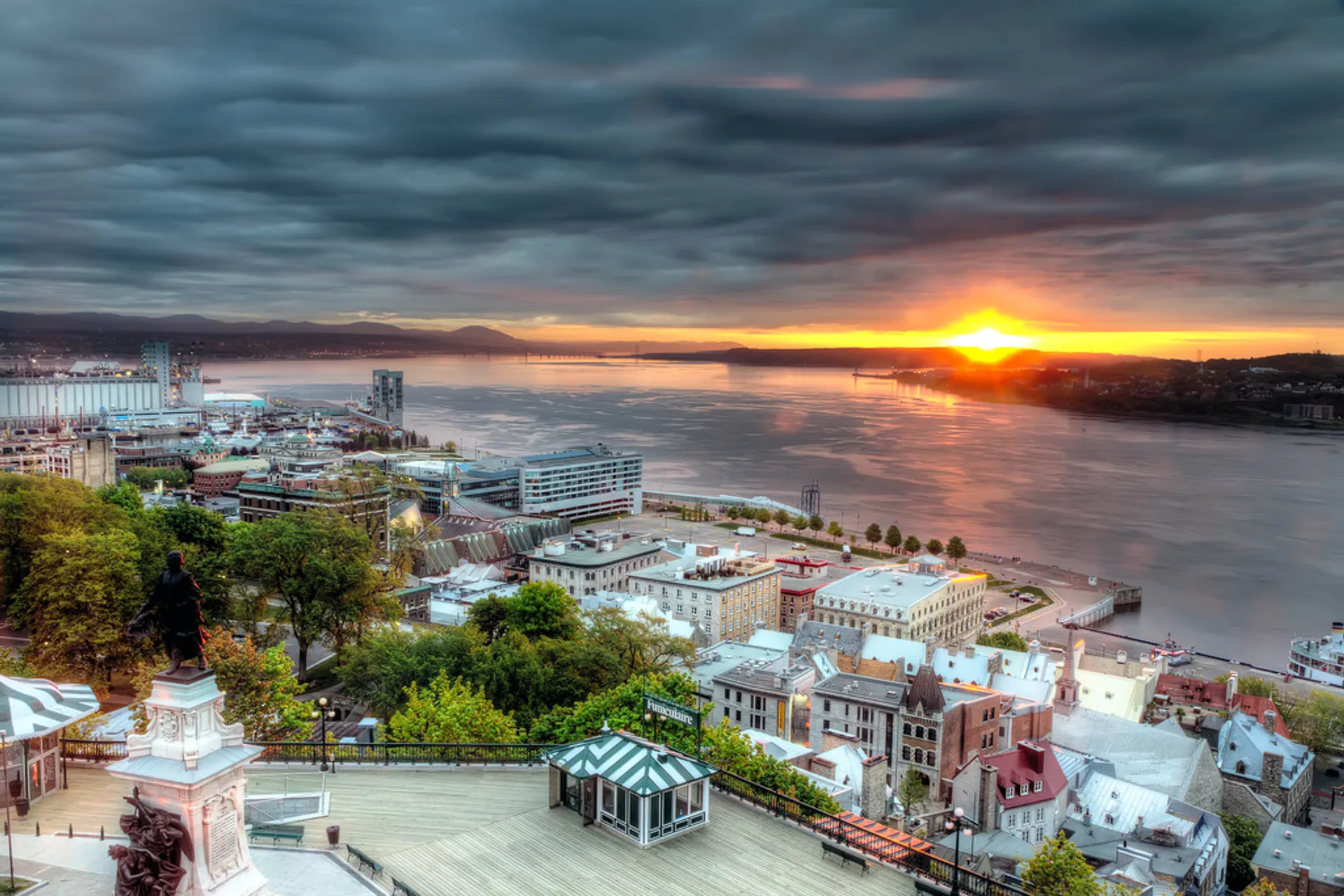 This image shows a beautiful aerial view of a city at sunrise or sunset. The