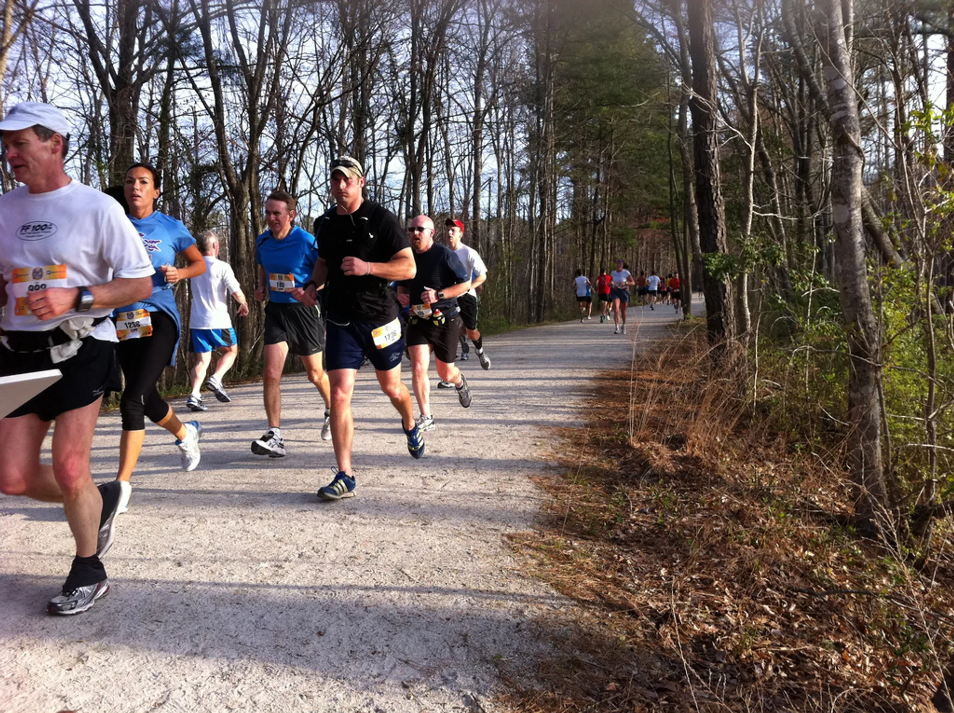 The image shows a group of runners participating in a race or marathon. They are