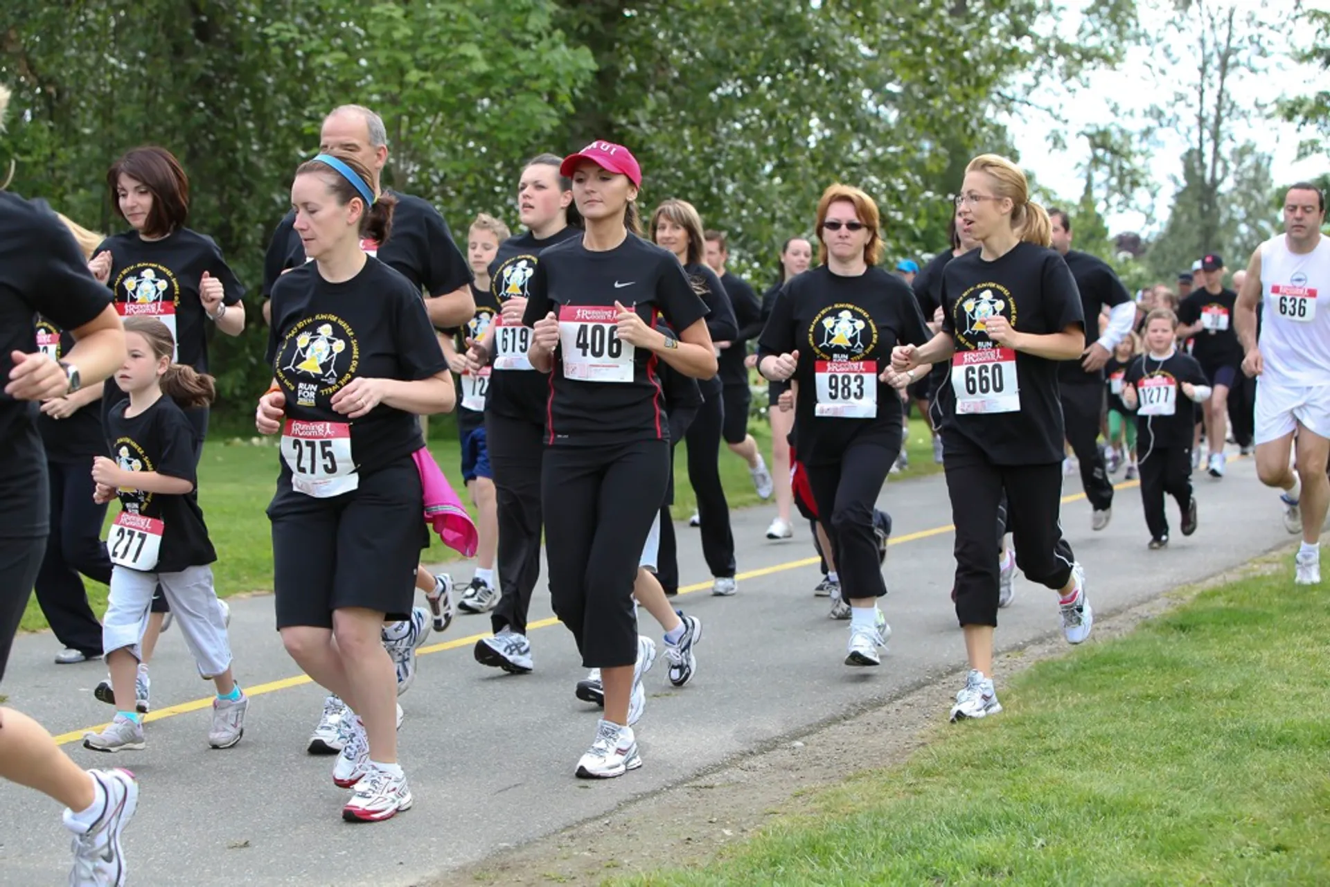 In this image, there is a group of people participating in a running event or