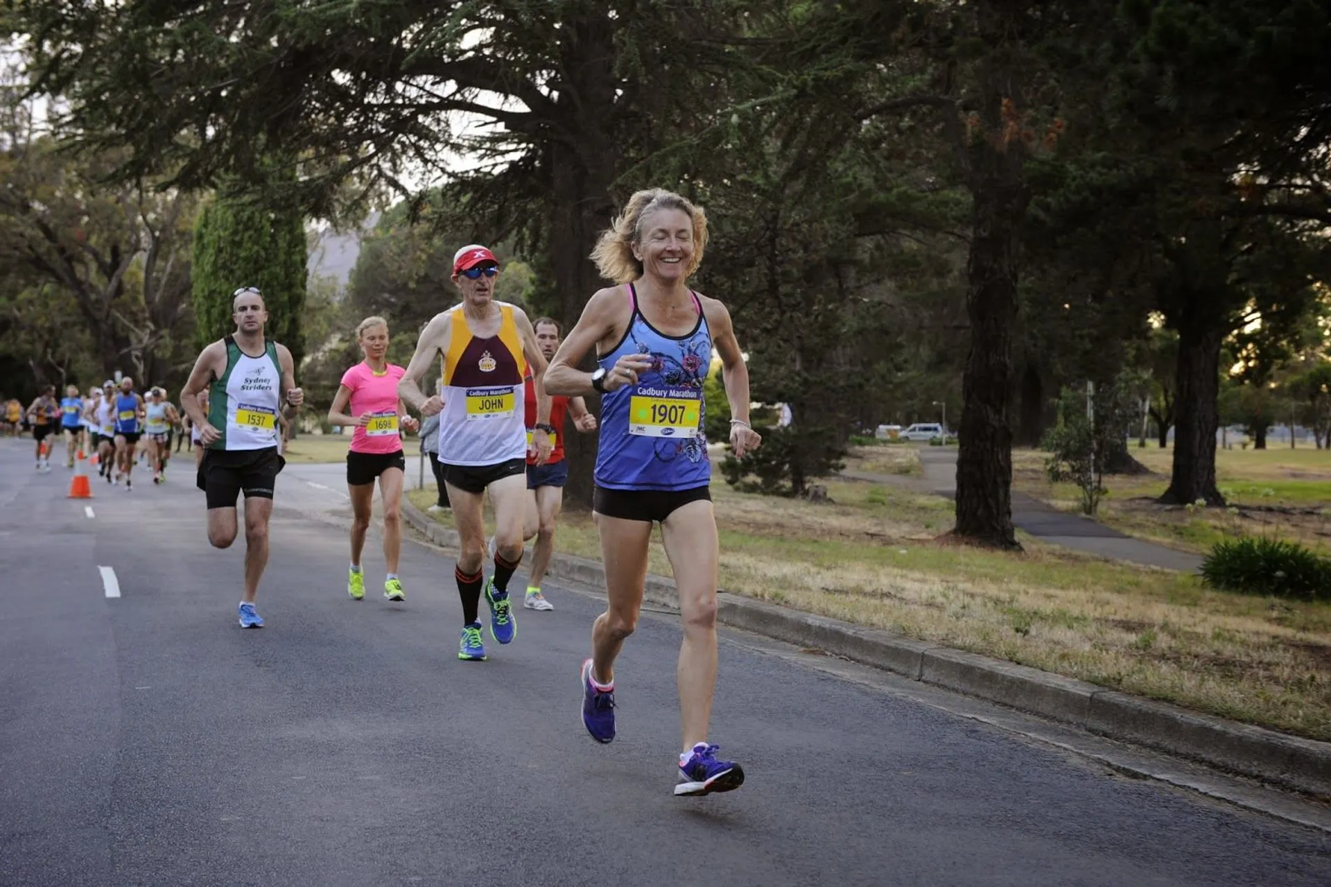 This image shows a group of people participating in a road running event or marathon.