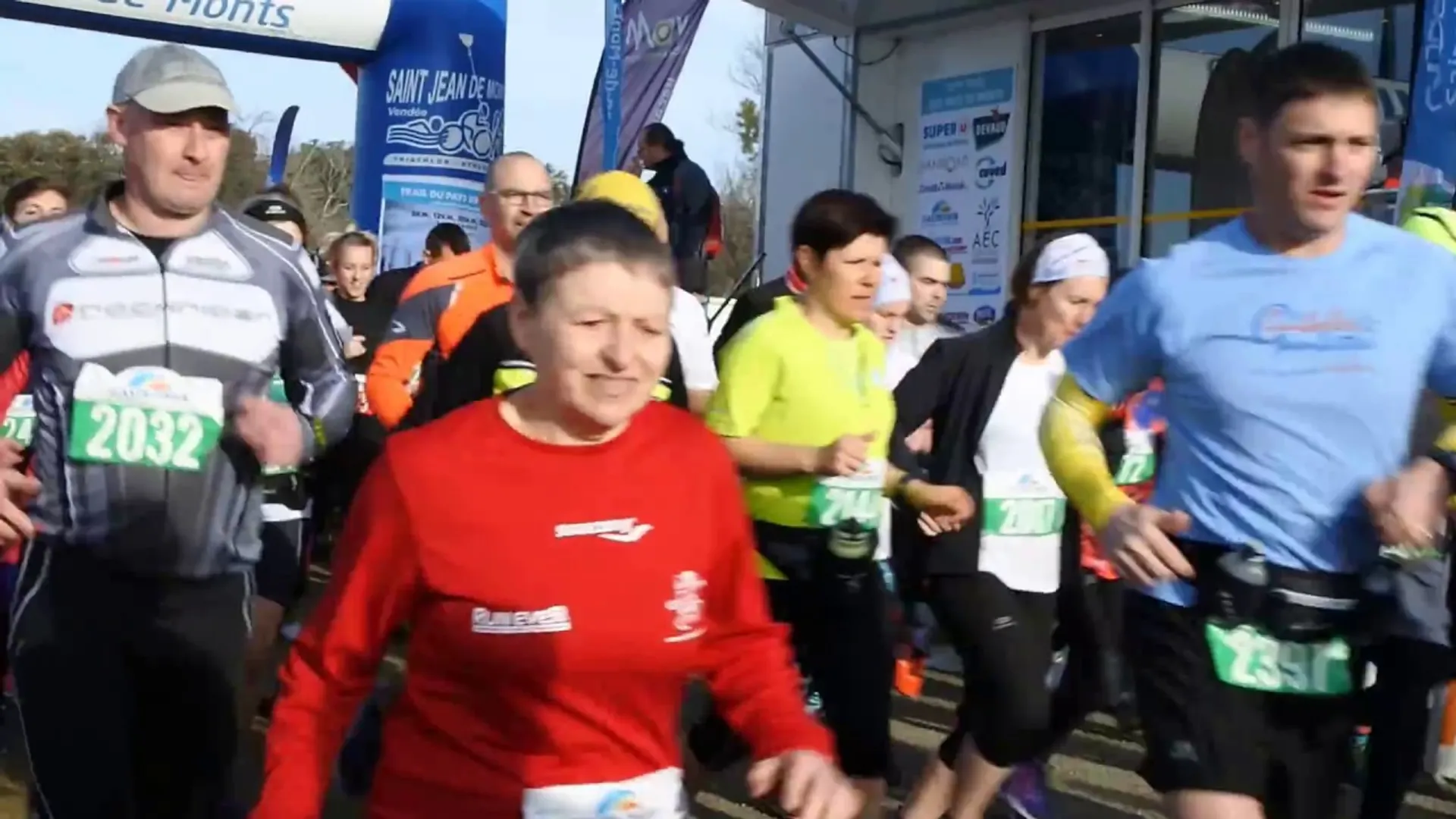 The image depicts a group of people participating in a running event or marathon. They