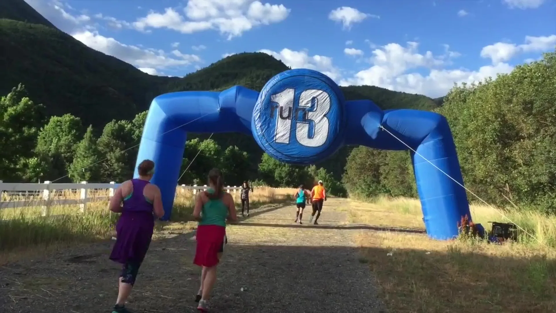 The image depicts an outdoor setting with a large inflatable arch, which seems to be
