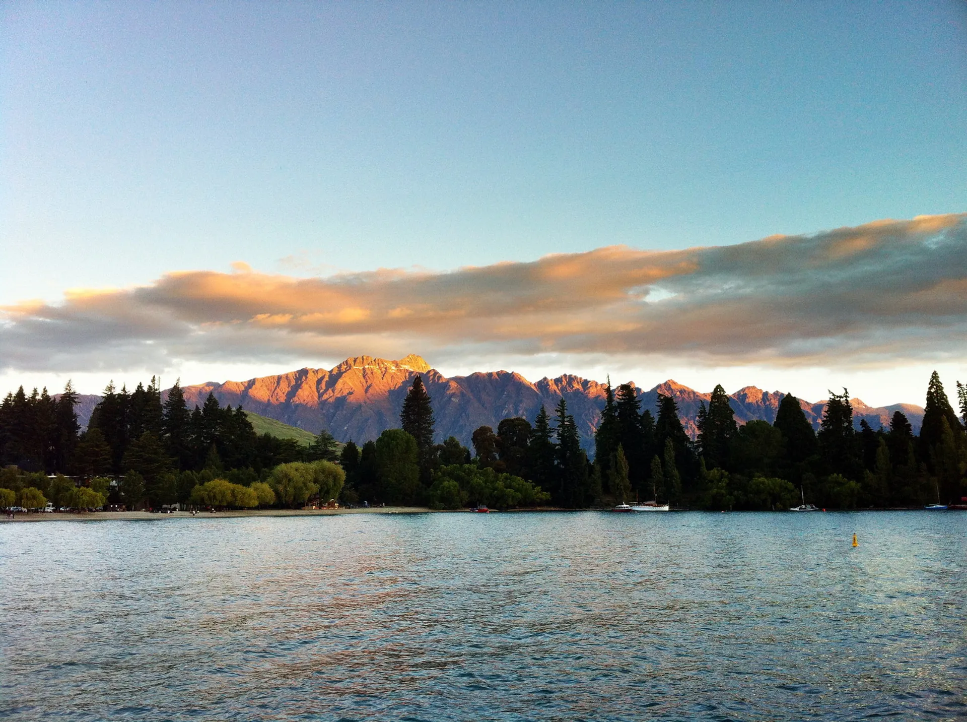 This image displays a beautiful scenic view where the foreground is dominated by a body of