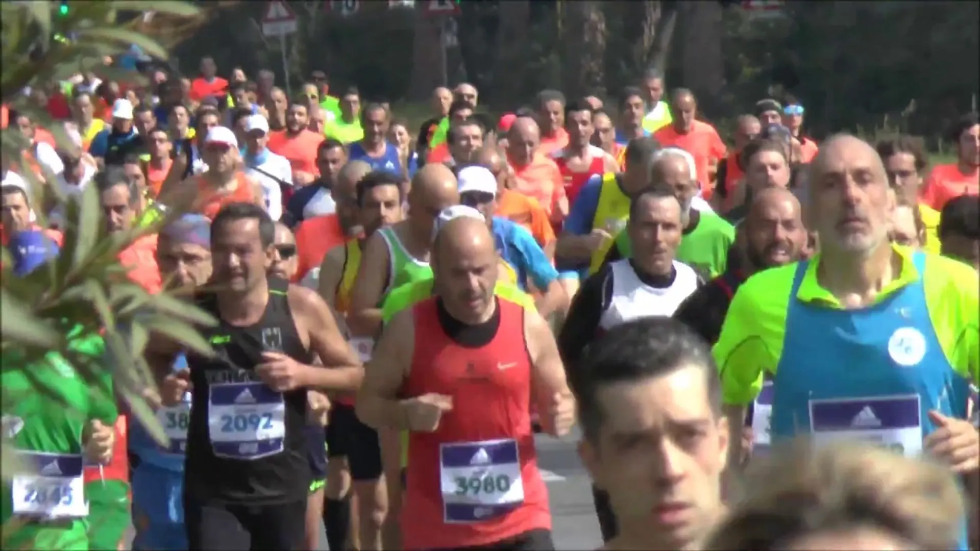 The image shows a group of people participating in a running event, possibly a marathon